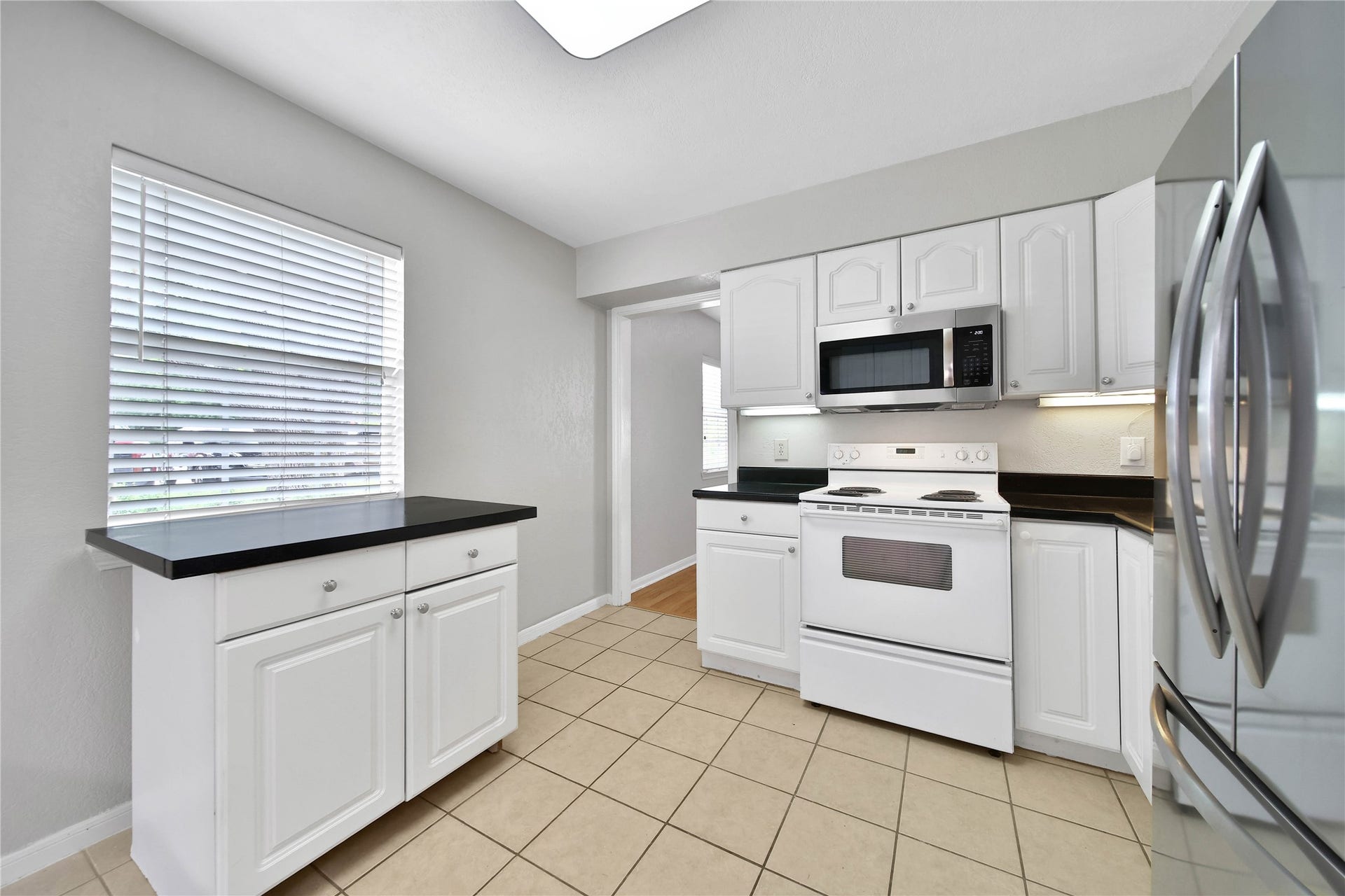 307 Lawrence Street, Tomball, TX 77375 Kitchen island has great storage and is movable to suit your needs.
