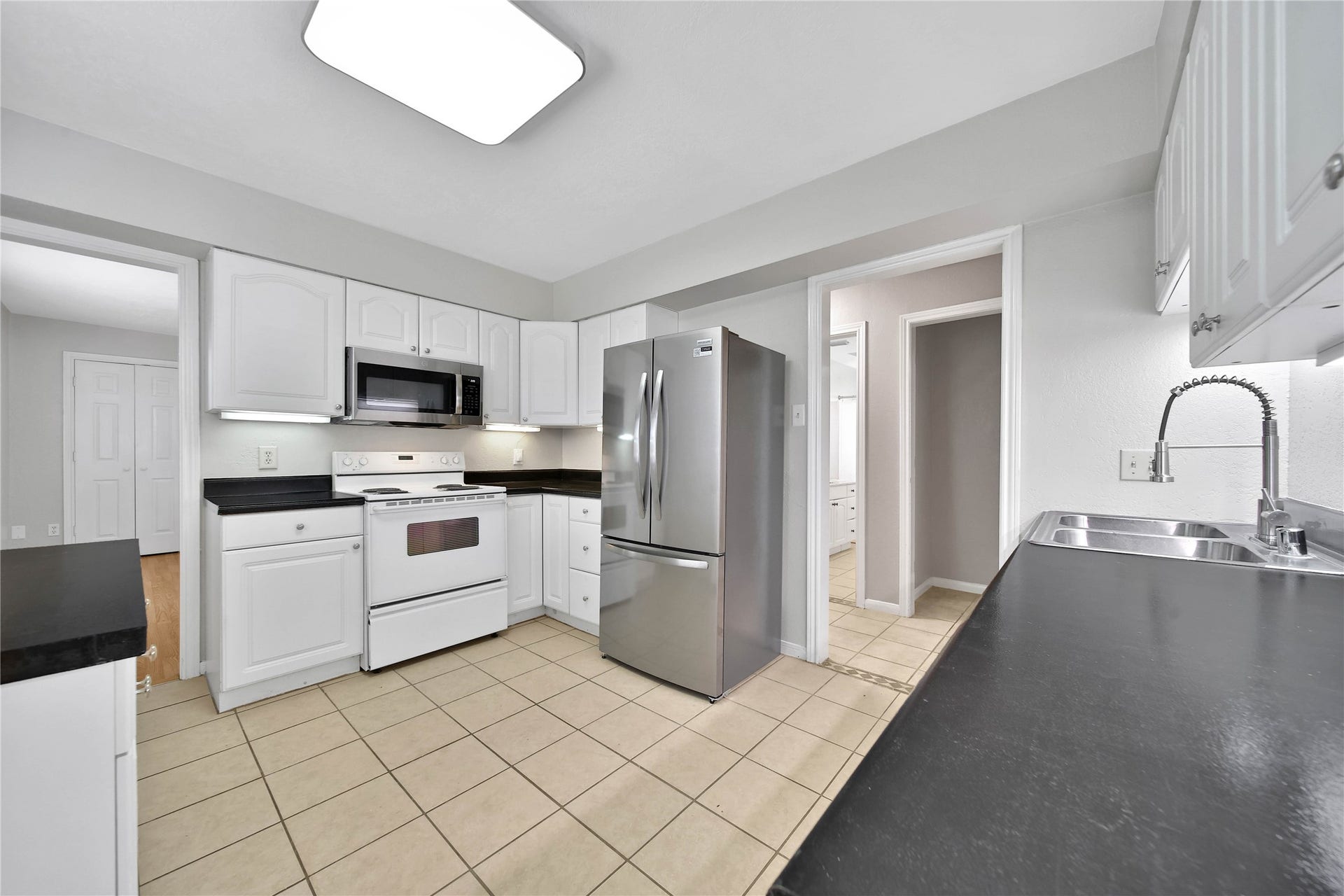 307 Lawrence Street, Tomball, TX 77375 The kitchen has entry from the dining room & the hallway leading to the bedrooms.