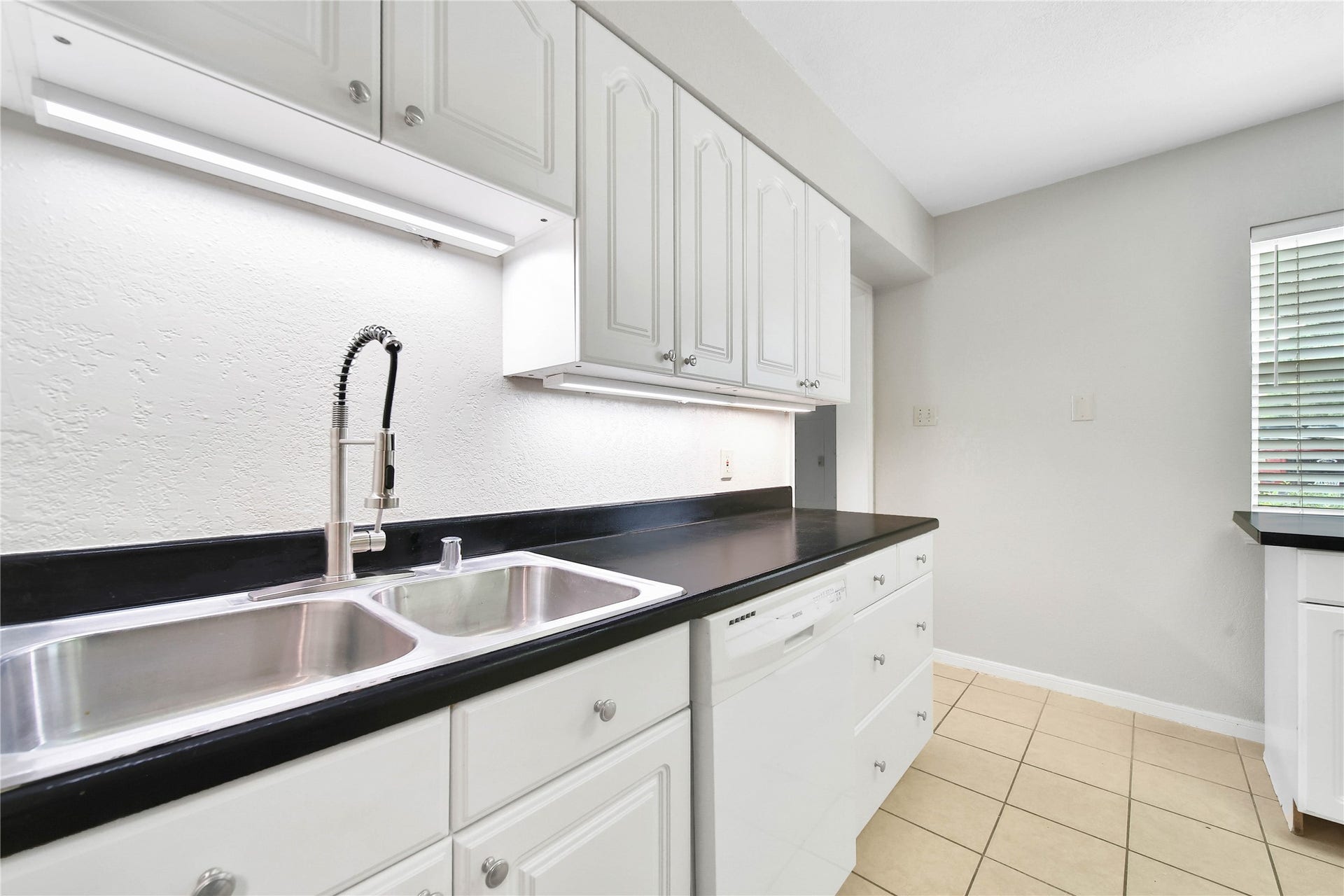 307 Lawrence Street, Tomball, TX 77375 Stainless sink and faucet. Notice the under-counter lighting...