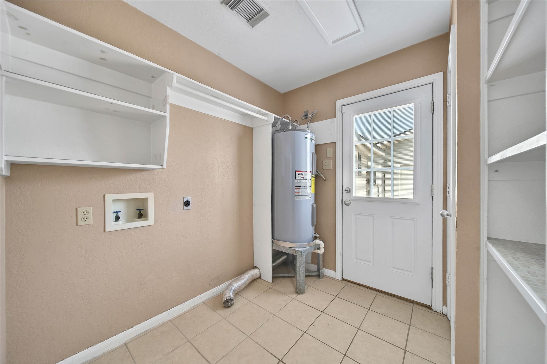 307 Lawrence Street, Tomball, TX 77375 Laundry/utility room has great storage & easy access to the detached garage. A great way to unload groceries close to the kitchen!
