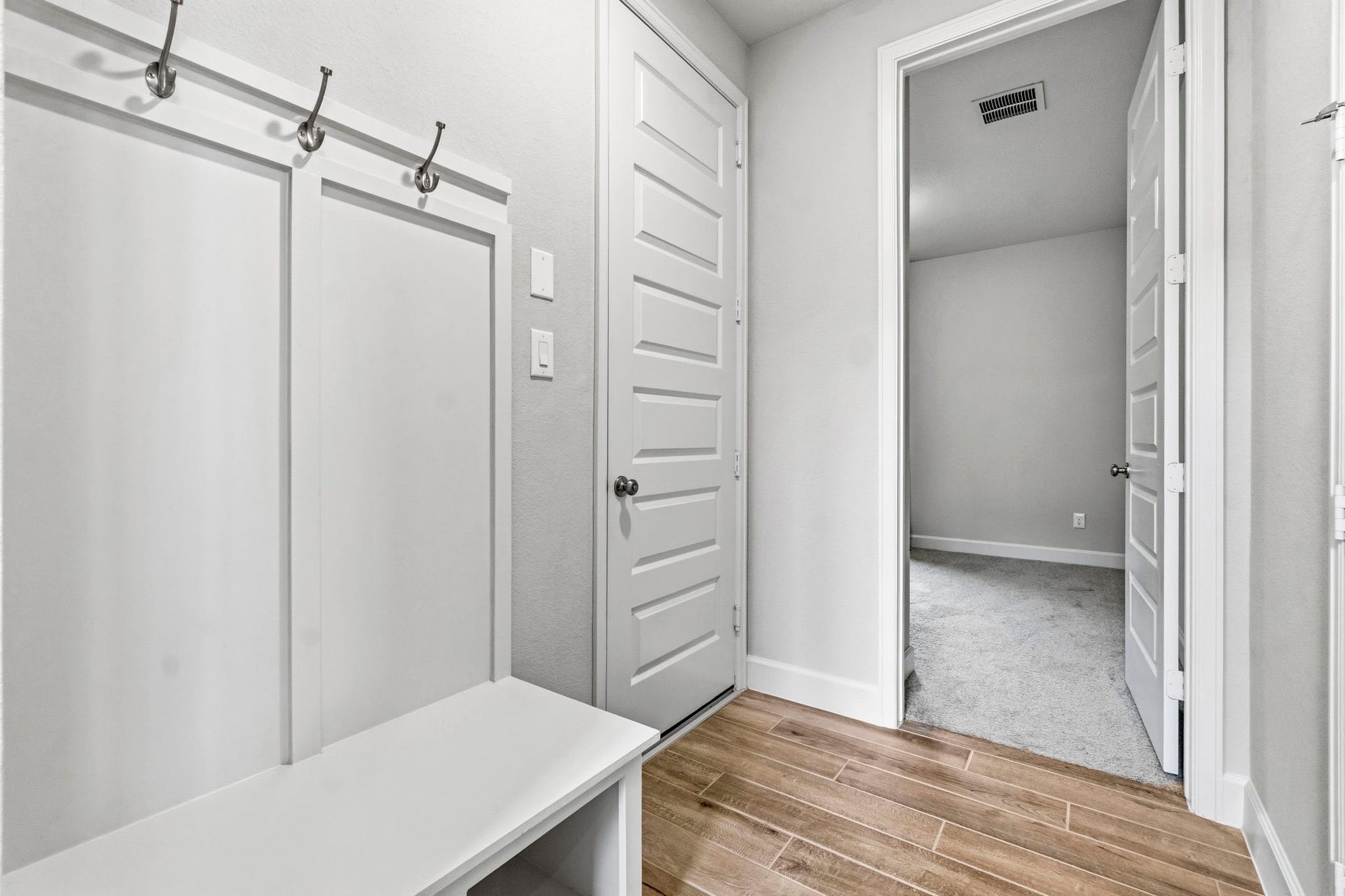 1147 Beals Creek Street, Conroe, TX 77304 Just inside the garage entry, a convenient mudroom provides the perfect drop zone for backpacks, coats, and everyday essentials. At the end of the hall, you'll find a private secondary bedroom and a full bathroom, ideal for guests or family.