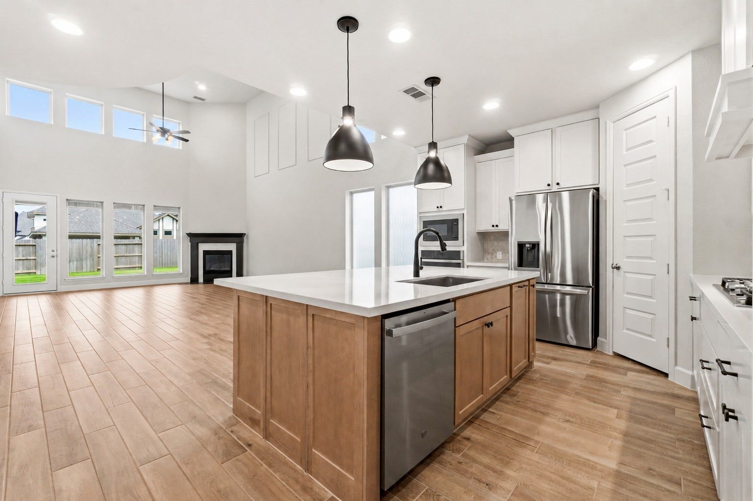 1147 Beals Creek Street, Conroe, TX 77304 The thoughtfully designed open-concept plan seamlessly connects the kitchen, dining area, and family room, creating the perfect space for everyday living and entertaining.