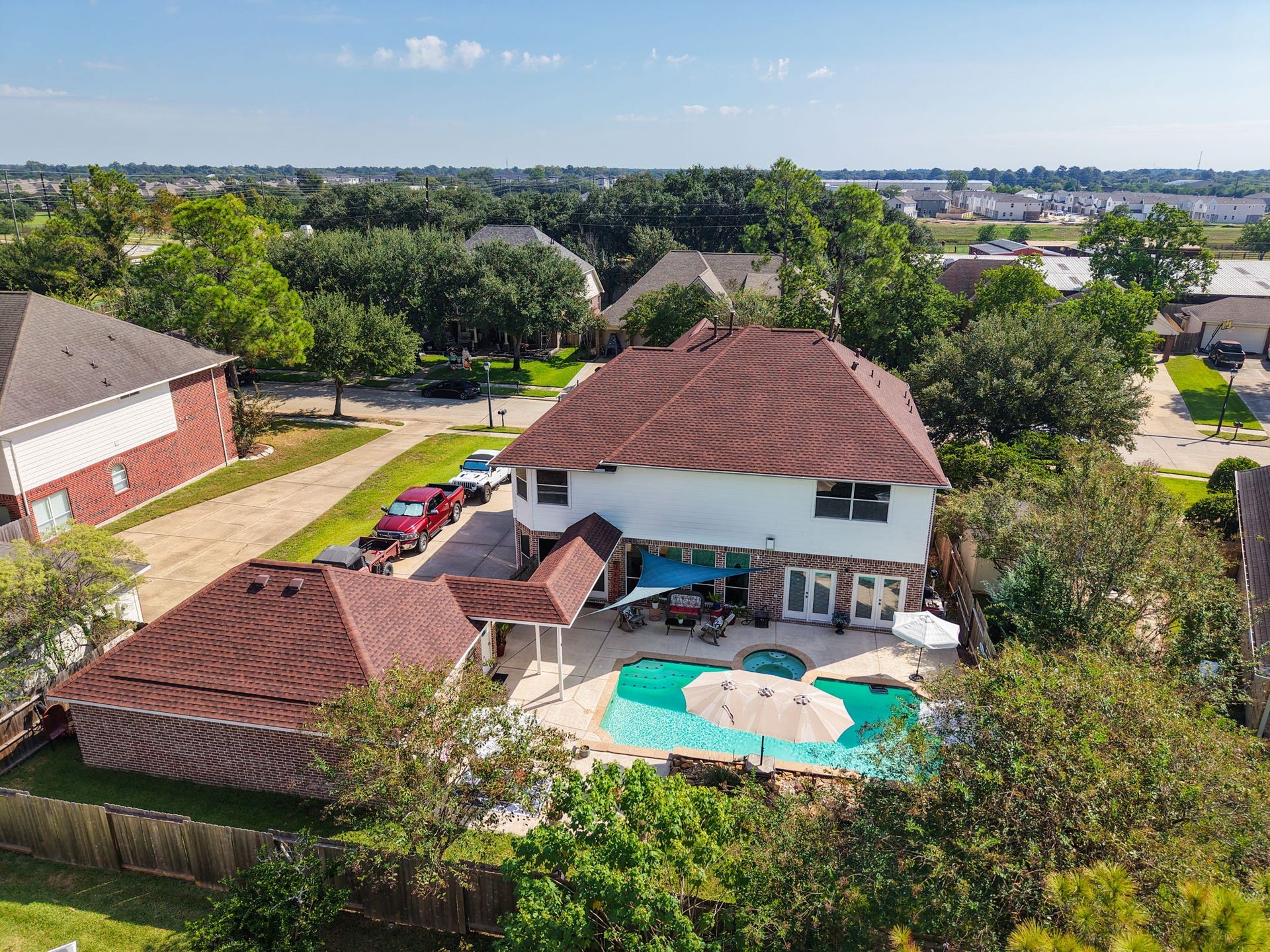 16319 Rolling View Trail, Cypress, TX 77433 A view of the backyard, notice the 3 car wide driveway and extra space behind the garage. Plenty of green space for the dog.