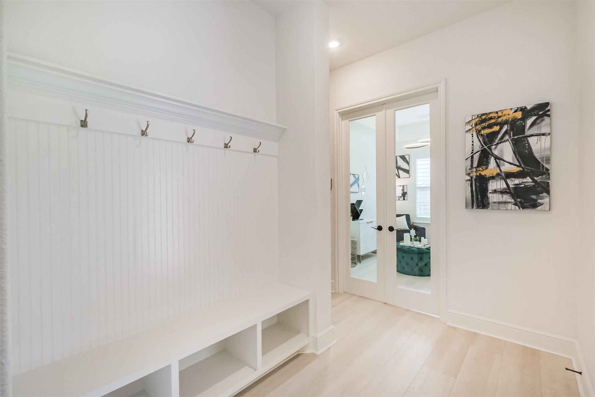 13611 Saddlebred Springs Lane, Cypress, TX 77429 Back inside the main residence, the thoughtfully designed mudroom is conveniently positioned just off the garage and adjacent to the private guest suite, providing a functional transition space for everyday living.