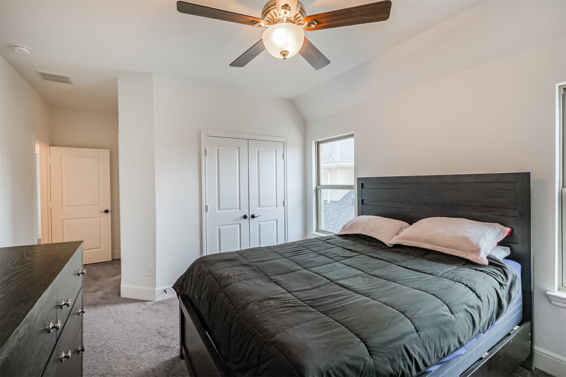 13611 Saddlebred Springs Lane, Cypress, TX 77429 Inviting fourth bedroom located upstairs, featuring a dramatic vaulted ceiling, abundant natural light, and a spacious closet offering generous storage. A private en-suite bathroom completes the space, providing added comfort and convenience.