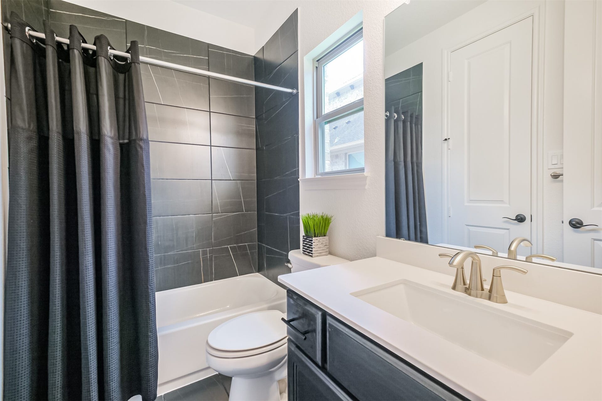 13611 Saddlebred Springs Lane, Cypress, TX 77429 Private downstairs guest suite/third bedroom is complete with its own beautifully appointed en-suite bathroom, featuring a sleek tiled tub and shower combinationoffering guests comfort, convenience, and exceptional privacy.
