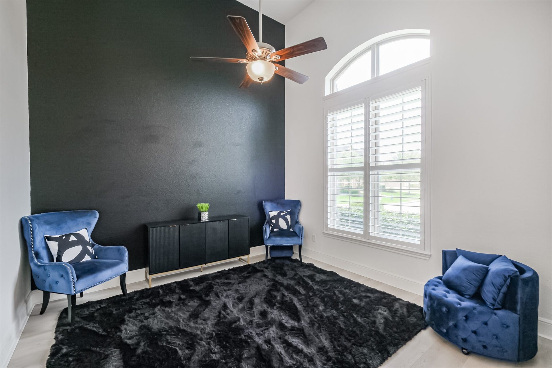 13611 Saddlebred Springs Lane, Cypress, TX 77429 The sophisticated study, ideally positioned just off the grand foyer, features soaring ceilings and abundant natural light streaming through an impressive arched window framed by classic plantation shutters.