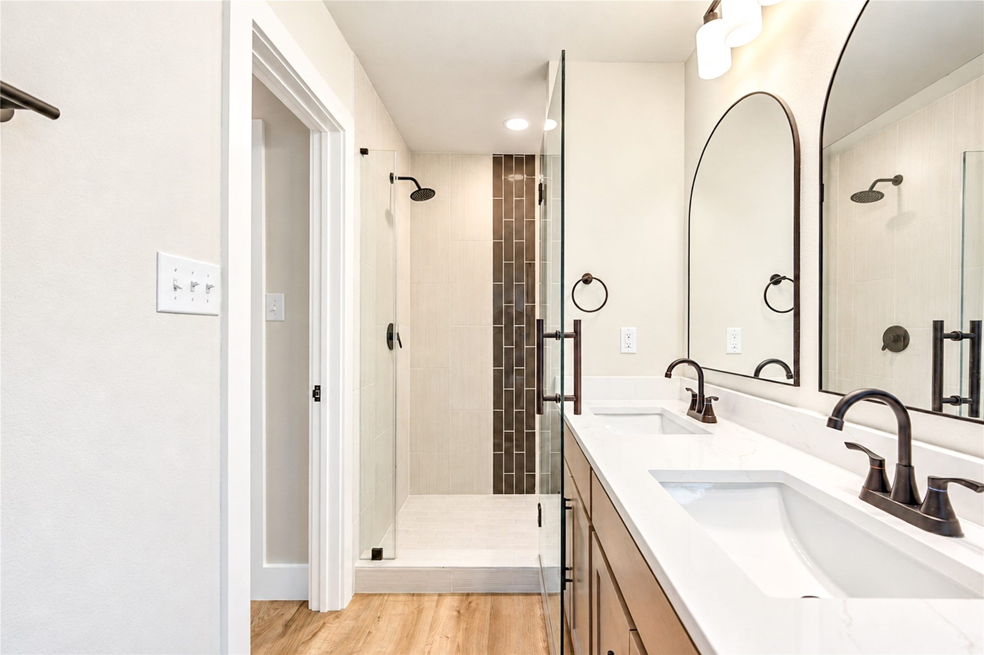 10607 Del Monte Drive, Houston, TX 77042 Stunning new primary shower showcases vertically installed 12x24 tile, decorative glass mosaic accents, and a sleek new frameless glass shower door. Home features all-new PEX plumbing throughout!