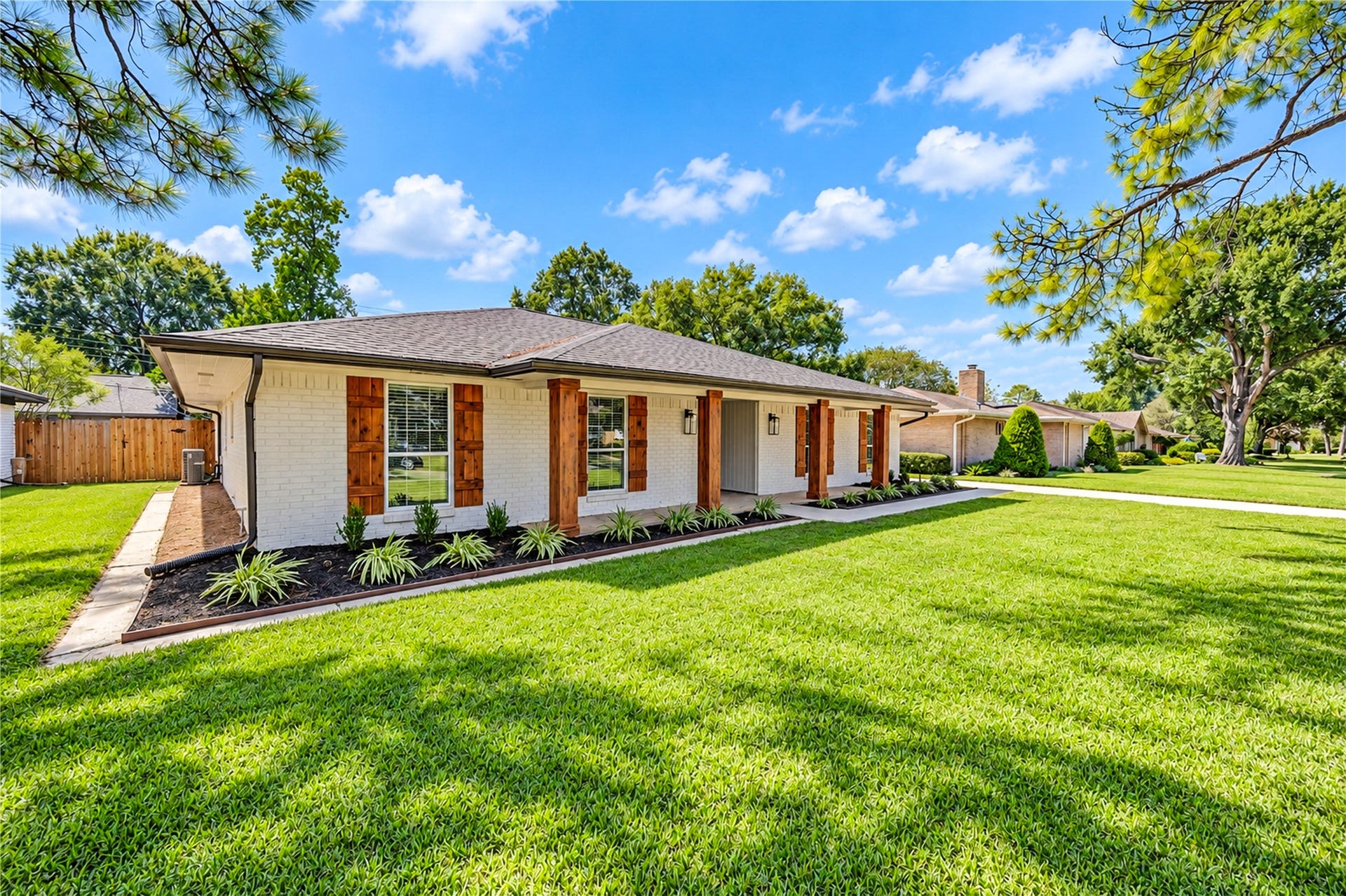 10607 Del Monte Drive, Houston, TX 77042 Inviting entrance showcases a new front door with frosted-glass sidelights, cedar-look columns, and updated exterior lighting.