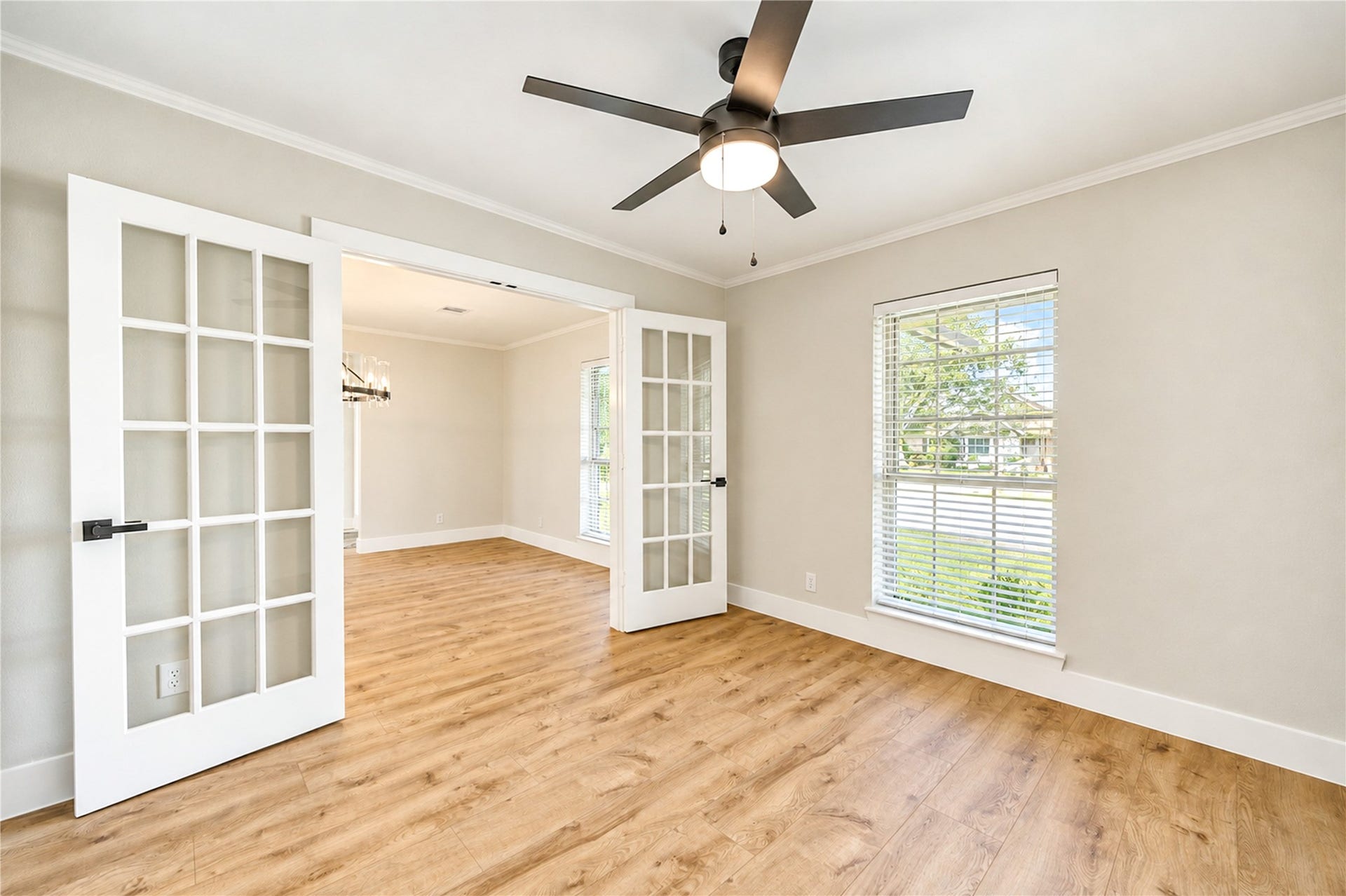 10607 Del Monte Drive, Houston, TX 77042 Beautifully converted from a formal dining room into a private, versatile flex space featuring elegant French doors, a secondary entrance to the kitchen, new wide-plank engineered wood flooring, and a new ceiling fan. Ideal for a home office, game room, fitness room, nursery, or media room!