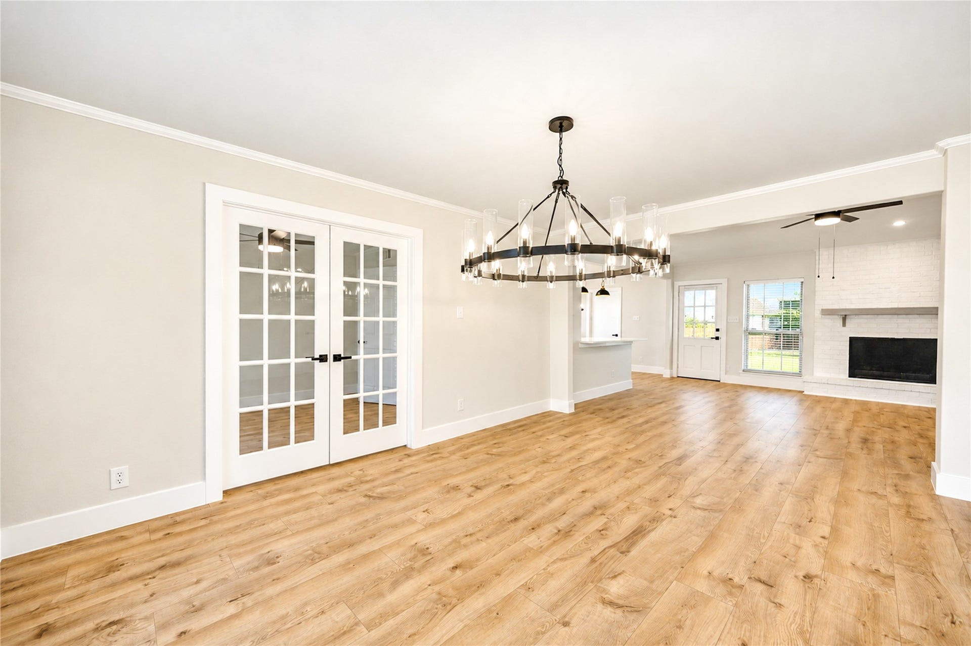 10607 Del Monte Drive, Houston, TX 77042 Another view of the formal dining room highlights the new designer chandelier, and seamless connection to the family room. Beyond the new double French doors is a convenient home office/study.