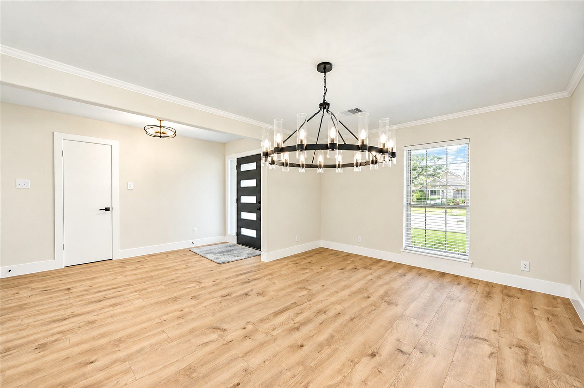 10607 Del Monte Drive, Houston, TX 77042 Elegant formal dining room features crown molding, abundant natural light, new wide-plank engineered wood flooring, and a stunning new statement chandelier.