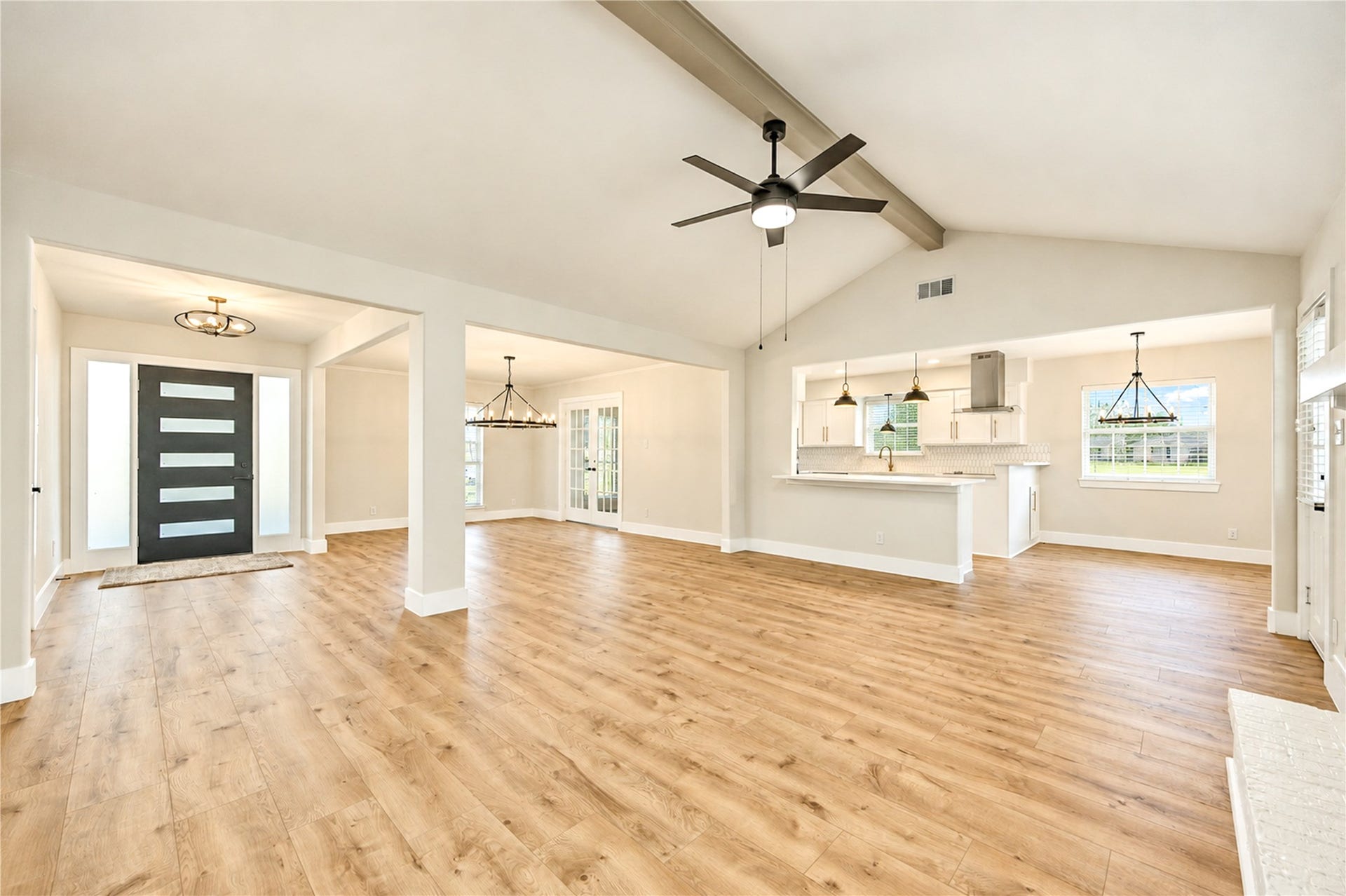 10607 Del Monte Drive, Houston, TX 77042 Beautifully redesigned open floor plan seamlessly connects the family room, kitchen, and dining areas, complemented by new wide-plank engineered wood flooring and updated designer lighting.