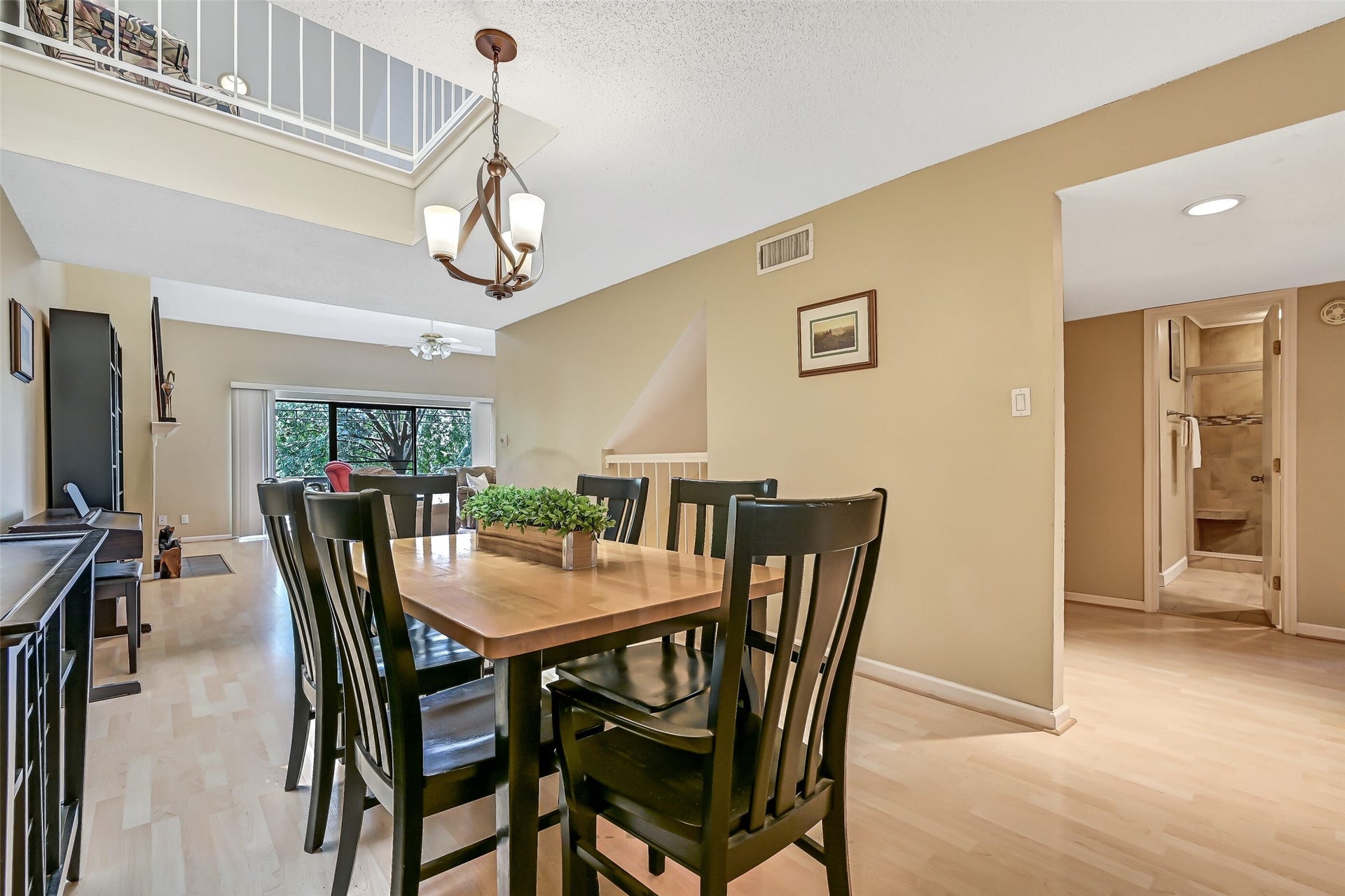 18214 Bal Harbour Drive, Nassau Bay, TX 77058 Another perspective of the second-floor formal dining area highlights the open railing overlooking the space from the third-floor loft. Just beyond the doorway to the right are two secondary bedrooms and a remodeled full bath, conveniently located on the same level as the main living spaces.
