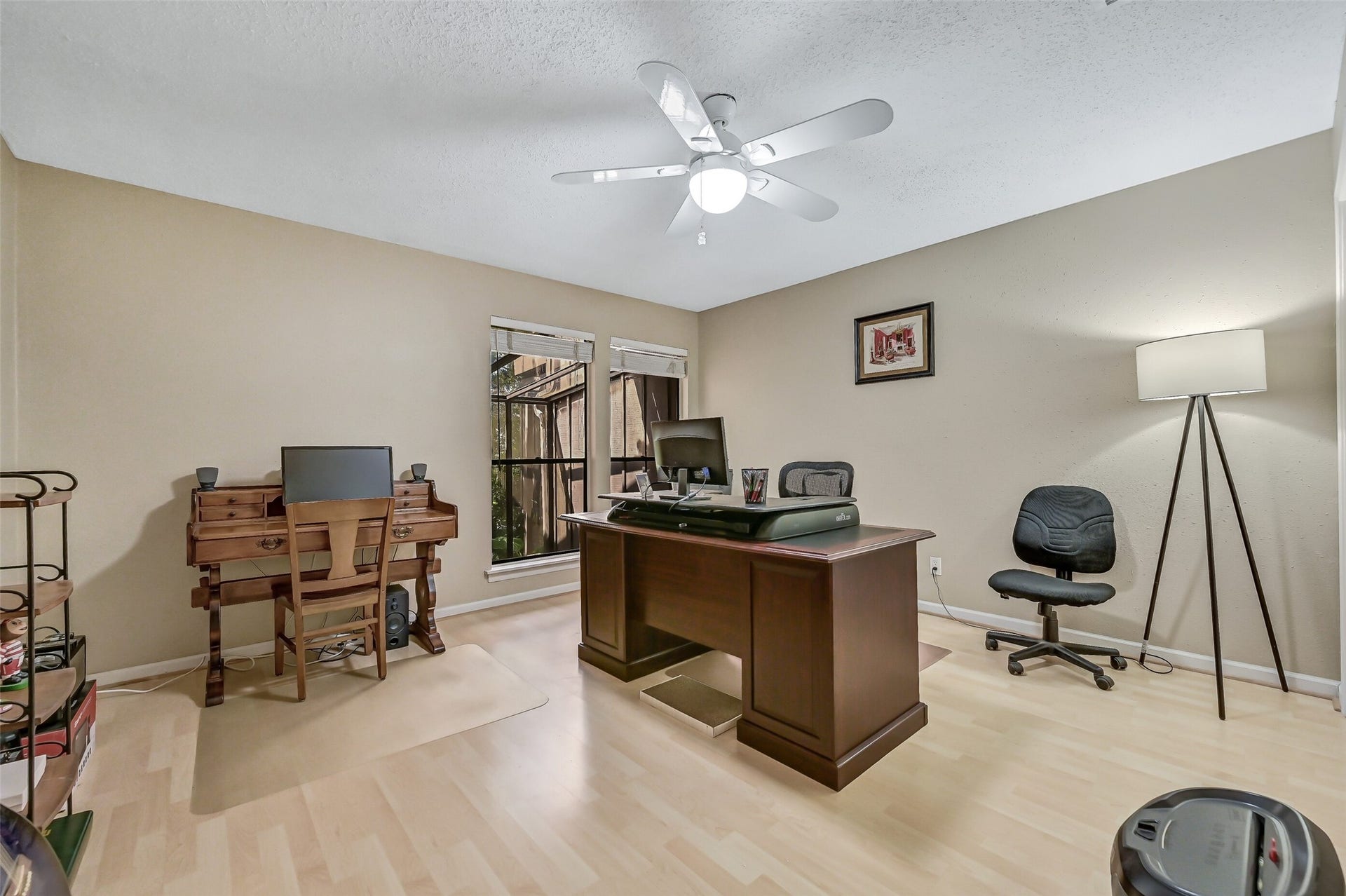 18214 Bal Harbour Drive, Nassau Bay, TX 77058 Currently used as a home office, this versatile second-flood bedroom features laminate flooring, a ceiling fan, bifold closet & windows overlooking the sunroom and canal. Originally open to the living room with a wet bar, the space offers flexibility for use as a bedroom, office, or additional entertainment area.