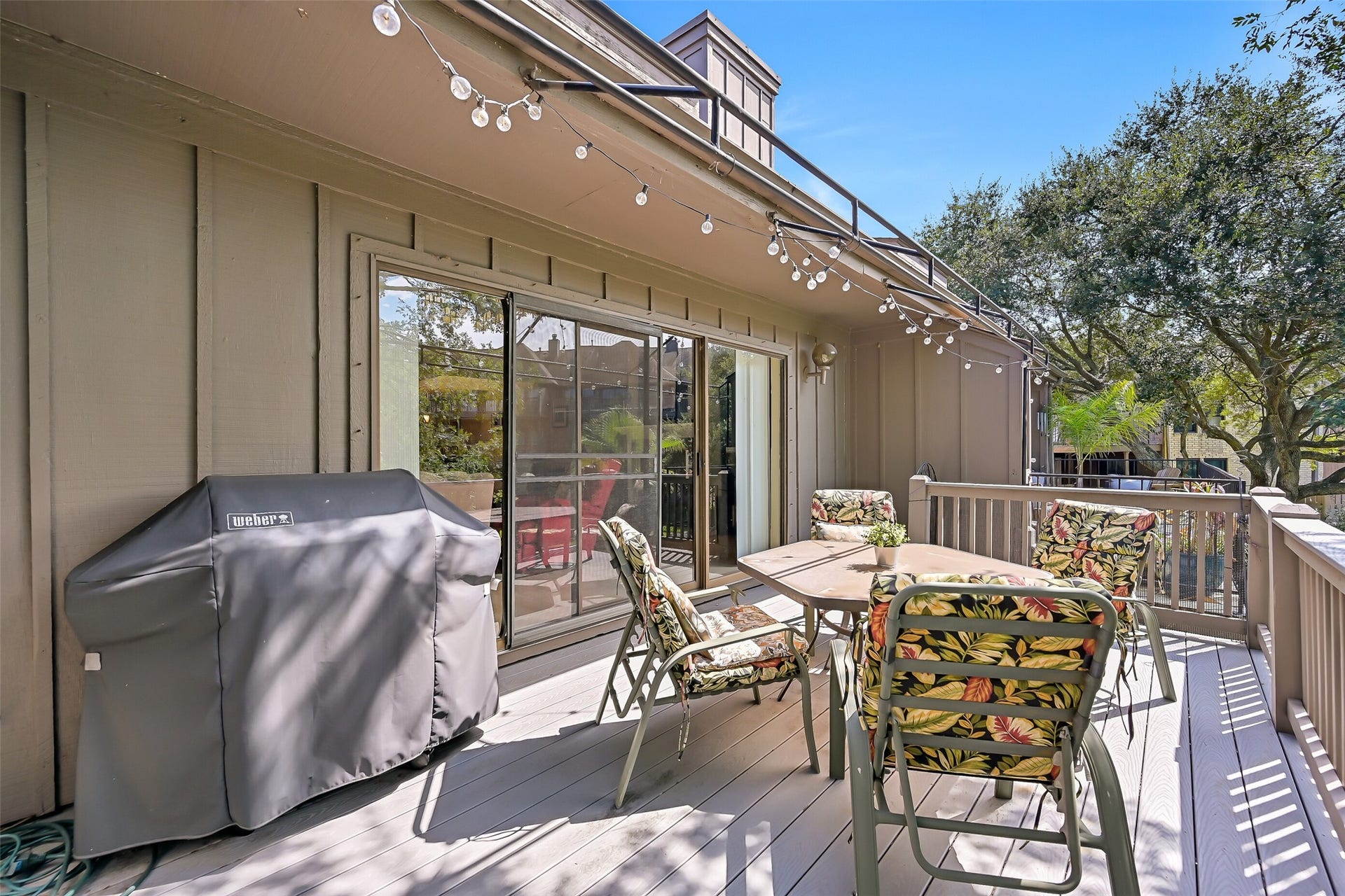 18214 Bal Harbour Drive, Nassau Bay, TX 77058 Step through the living room's sliding glass doors onto the impressive 21' x 11' extended, durable Trex-decked composite balcony! With ample room for outdoor dining, grilling & relaxing, this elevated outdoor space overlooks the canal beneath a canopy of mature trees, offering a peaceful setting to enjoy the waterfront surroundings.