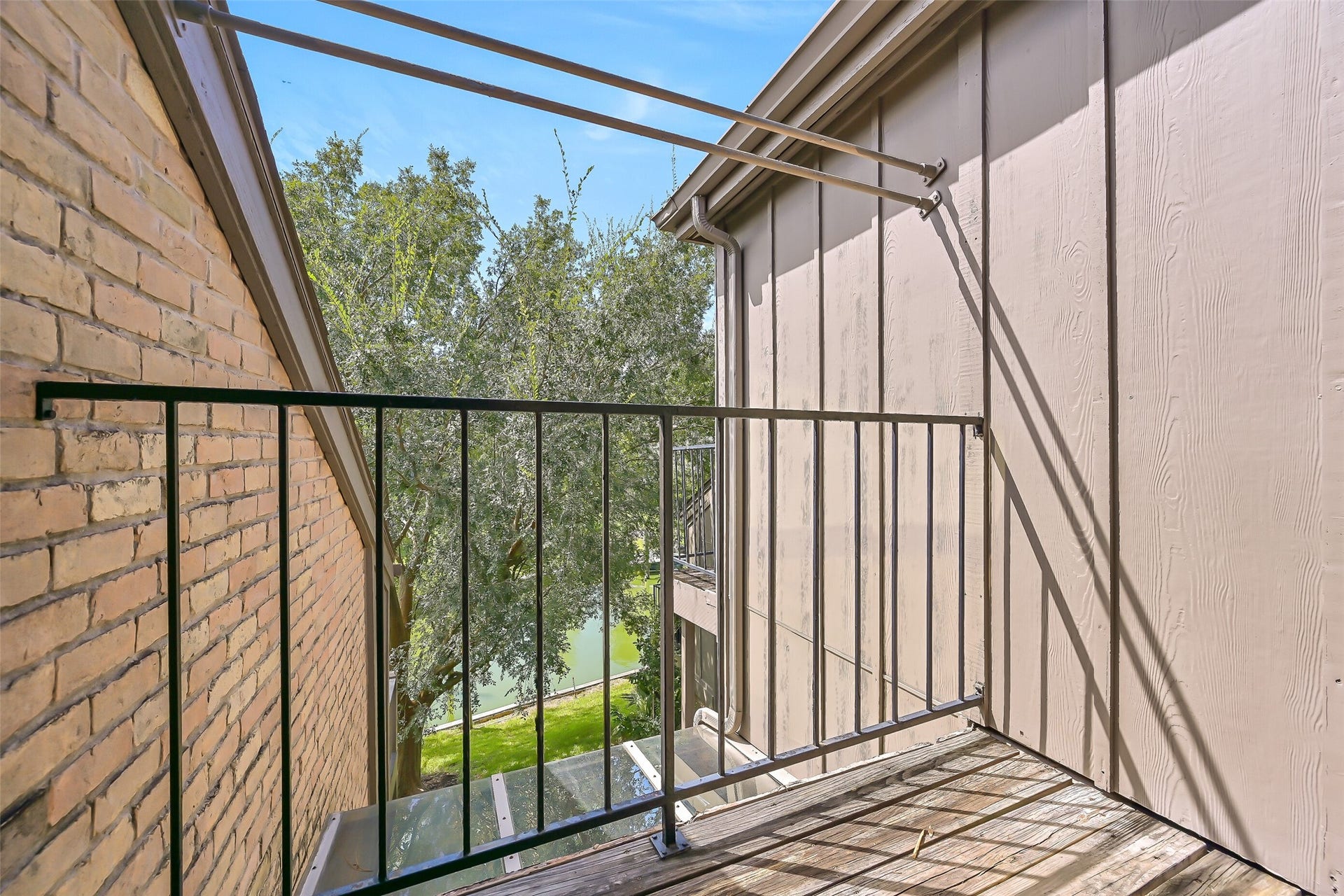 18214 Bal Harbour Drive, Nassau Bay, TX 77058 This private third-floor balcony is accessed directly from the primary bedroom sliding glass door, offering an elevated perspective through the mature trees toward the canal below. This intimate outdoor space provides another place to enjoy fresh air, waterfront surroundings & glimpses of the boats passing through Bal Harbour.
