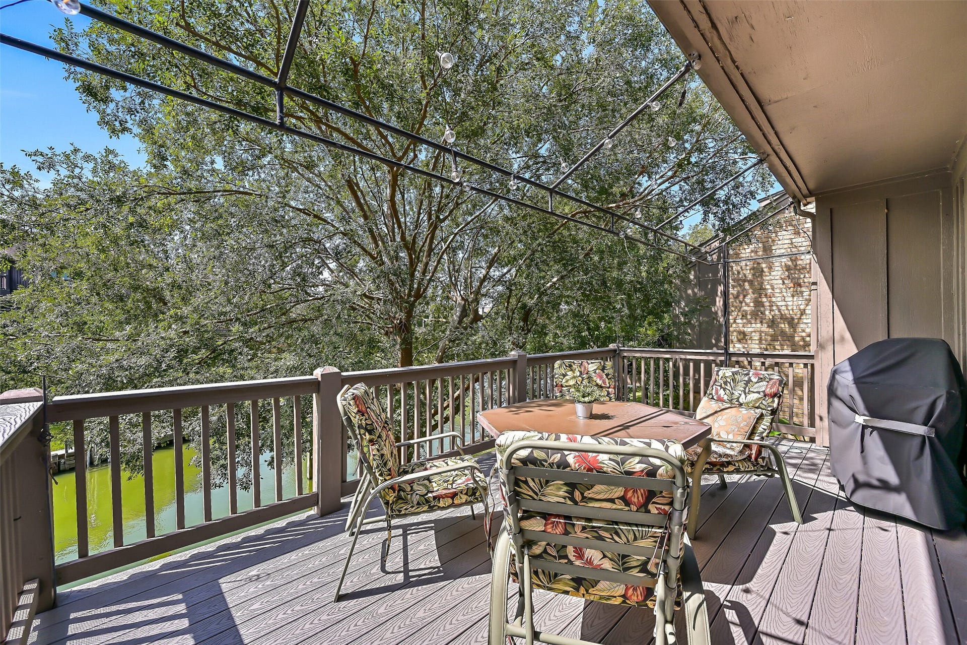 18214 Bal Harbour Drive, Nassau Bay, TX 77058 The spacious composite balcony feels almost like a treehouse, nestled among the branches of a mature Chinese Elm overlooking the canal. Enjoy shaded outdoor dining, watch boats passing through the nearby turn basin or settle in for the beautiful sunset views that make this waterfront setting so special.