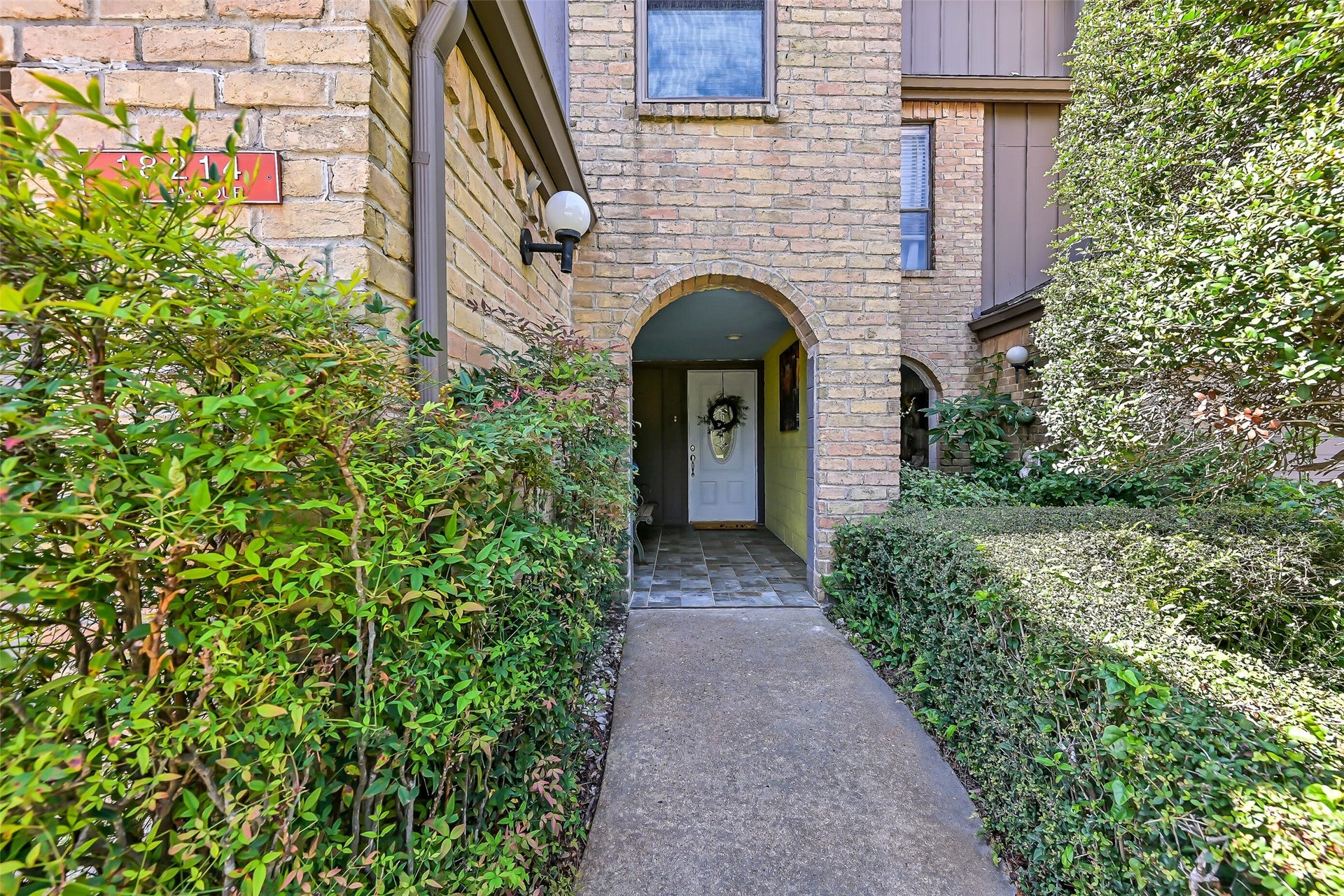 18214 Bal Harbour Drive, Nassau Bay, TX 77058 Your tour begins through a landscaped walkway that leads to the arched, covered entry, where non-slip, slate-look tile flooring, recessed lighting & a beveled-glass front door welcome you home. A convenient hidden side entrance to the attached garage is tucked beneath the same covered porch, providing sheltered access in any weather.
