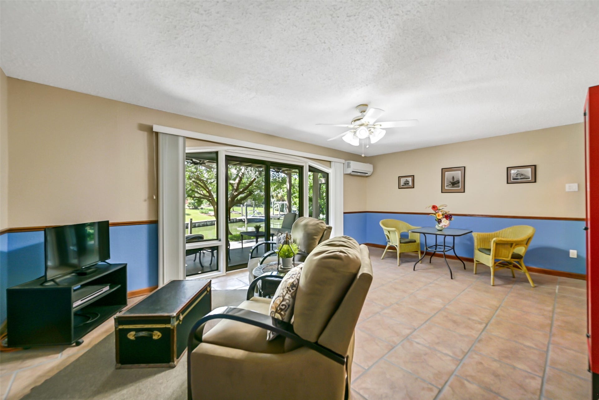 18214 Bal Harbour Drive, Nassau Bay, TX 77058 A wall of custom-built arched windows and sliding glass doors connects the ground-floor living area to a 22' x 12' covered tiled patio overlooking the canal. With a mini-split A/C, generous floor space & flexible furniture arrangements, this room works equally well as guest living quarters, a game room or a home office.