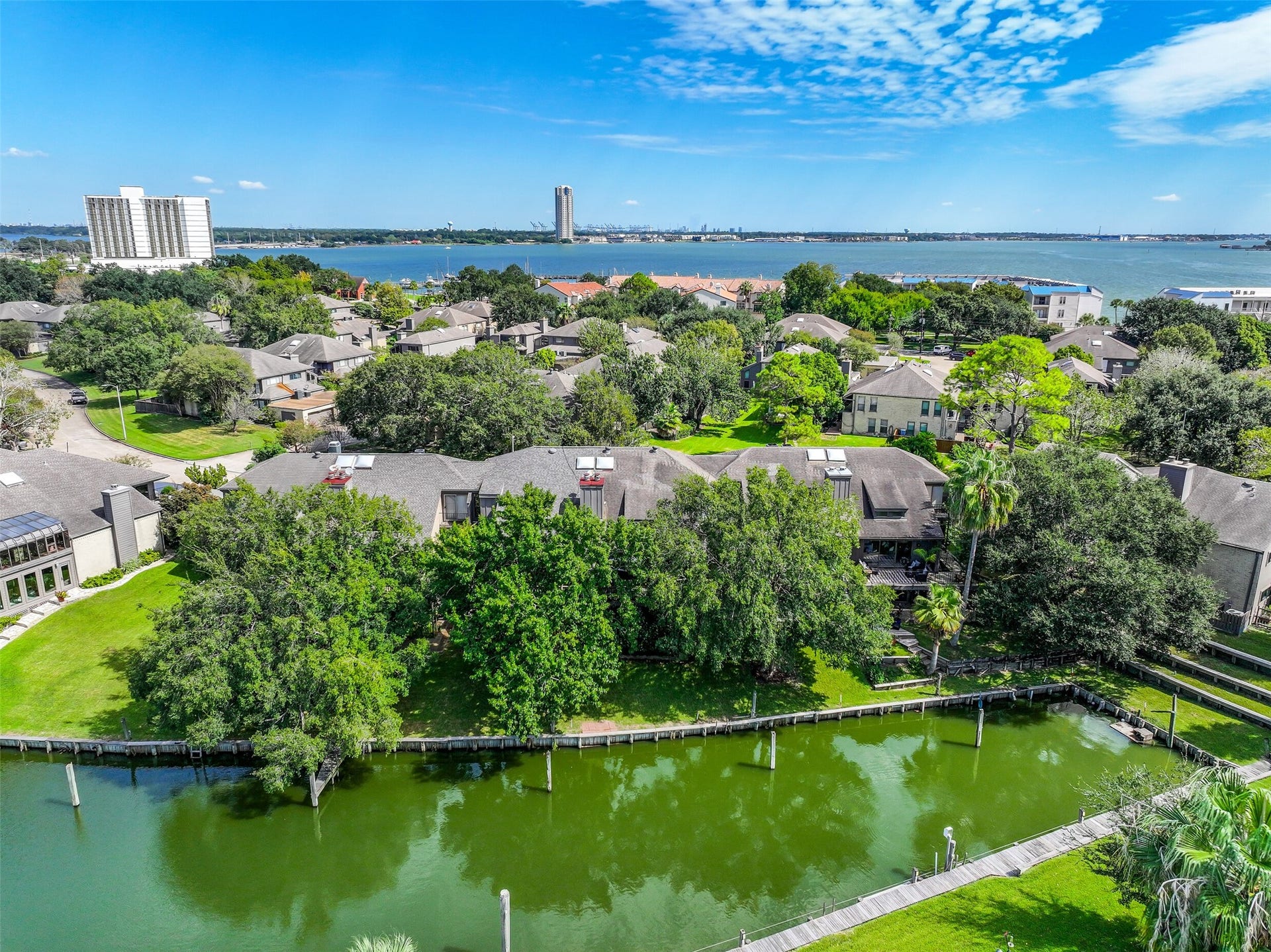 18214 Bal Harbour Drive, Nassau Bay, TX 77058 An aerial view of the canal directly behind 18214 Bal Harbour reveals the home's waterfront setting, surrounded by mature trees, with Clear Lake just beyond! Kayak, SUP or boat from your backyard to Clear Lake, Galveston Bay & beyond.