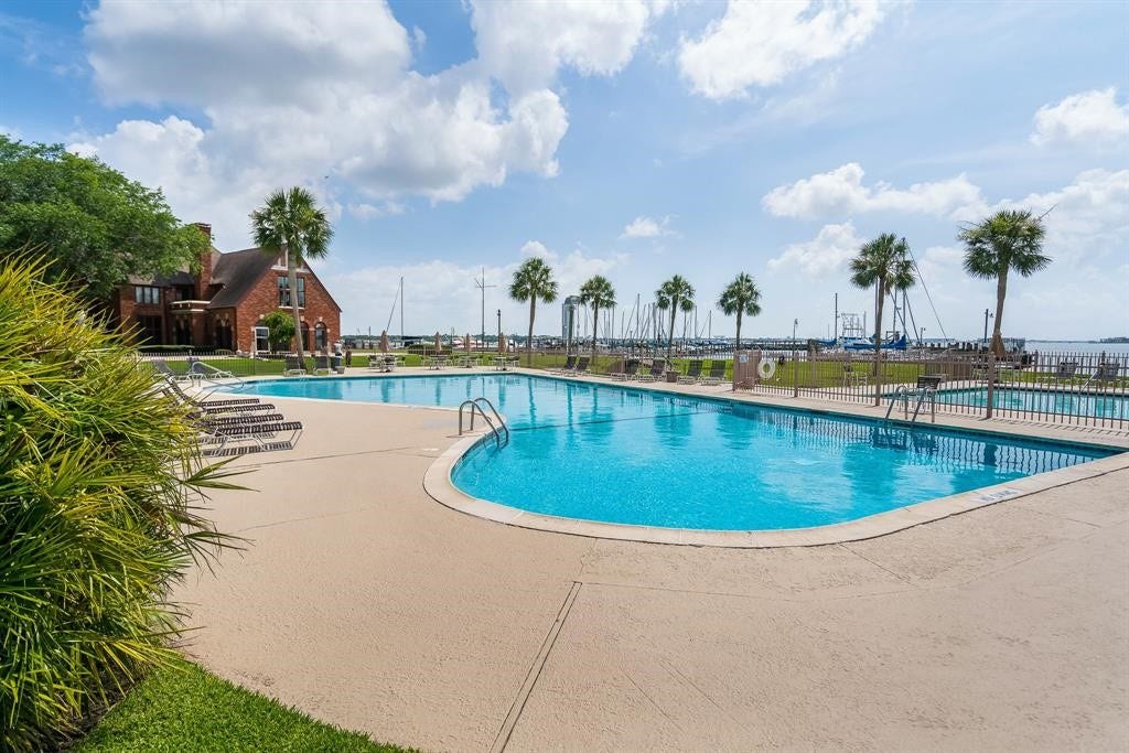 18214 Bal Harbour Drive, Nassau Bay, TX 77058 What a setting for a community pool! Bal Harbour residents enjoy this spacious waterfront swimming pool overlooking Clear Lake and the marina, with plenty of poolside seating, palm trees & a separate smaller pool. The historic Windemere Mansion stands nearby, adding to the character of this waterfront community.