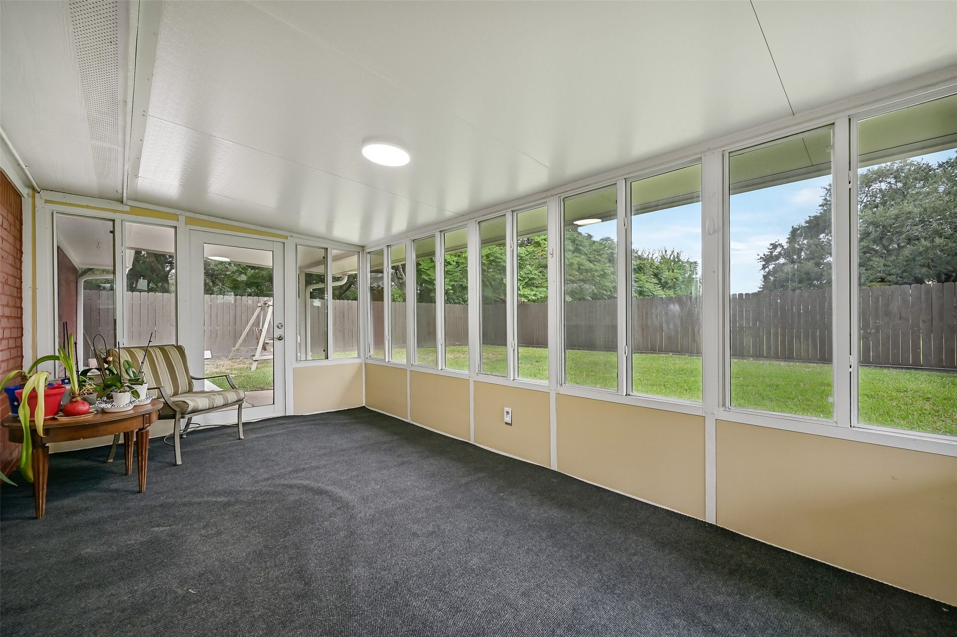 5403 Carmona Lane, Pearland, TX 77584 A fabulous extension of the living space, this 17' x 10' screened porch overlooks the backyard through walls of screened windows. Indoor/outdoor carpeting, flush-mount lighting & a window A/C unit make this a comfortable spot for relaxing, plants, hobbies or enjoying the outdoors with added shelter.