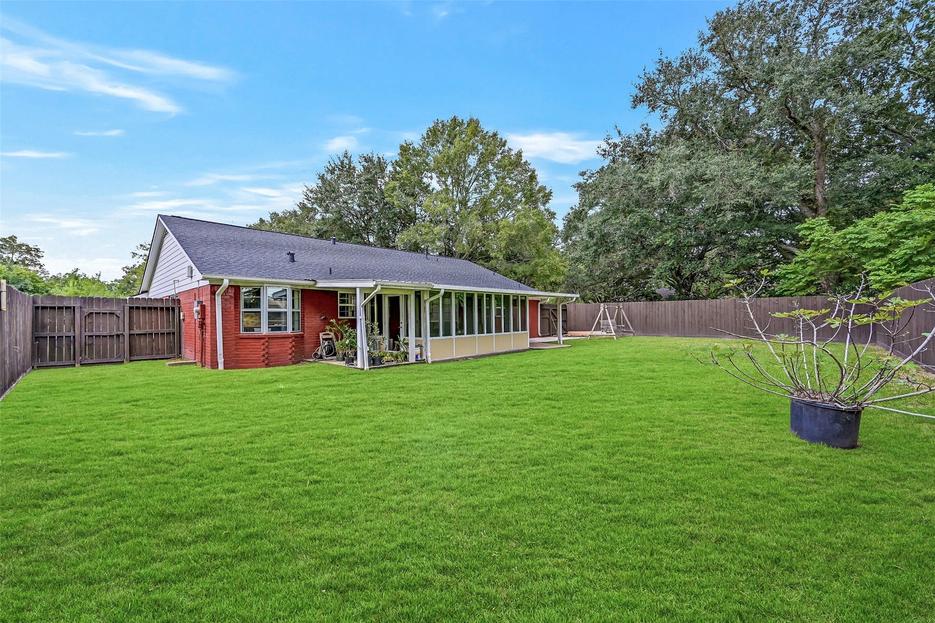 5403 Carmona Lane, Pearland, TX 77584 The expansive fenced backyard offers plenty of open grassy space for pets, play, gardening or future outdoor plans. Mature trees rise beyond the fence, while the screened porch, covered patio & additional patio area create multiple ways to enjoy the outdoors. No immediate rear neighbor adds to the open setting.