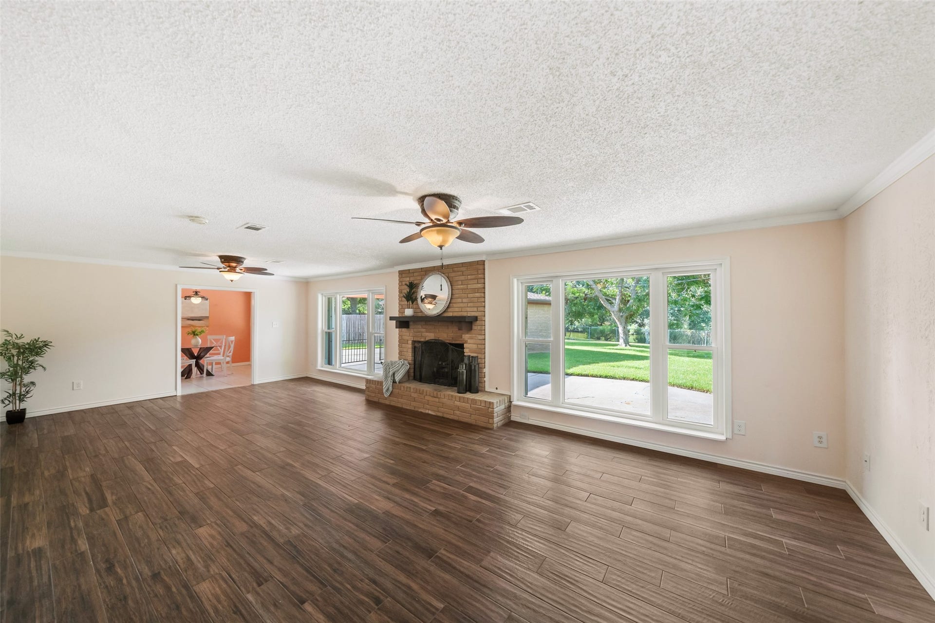 7714 Pecanwood Street, Hitchcock, TX 77563 Another great view of the living room. LOVE this wood-look tile in that begins in the entryway and extends seamlessly into the living room. Look at that VIEW!