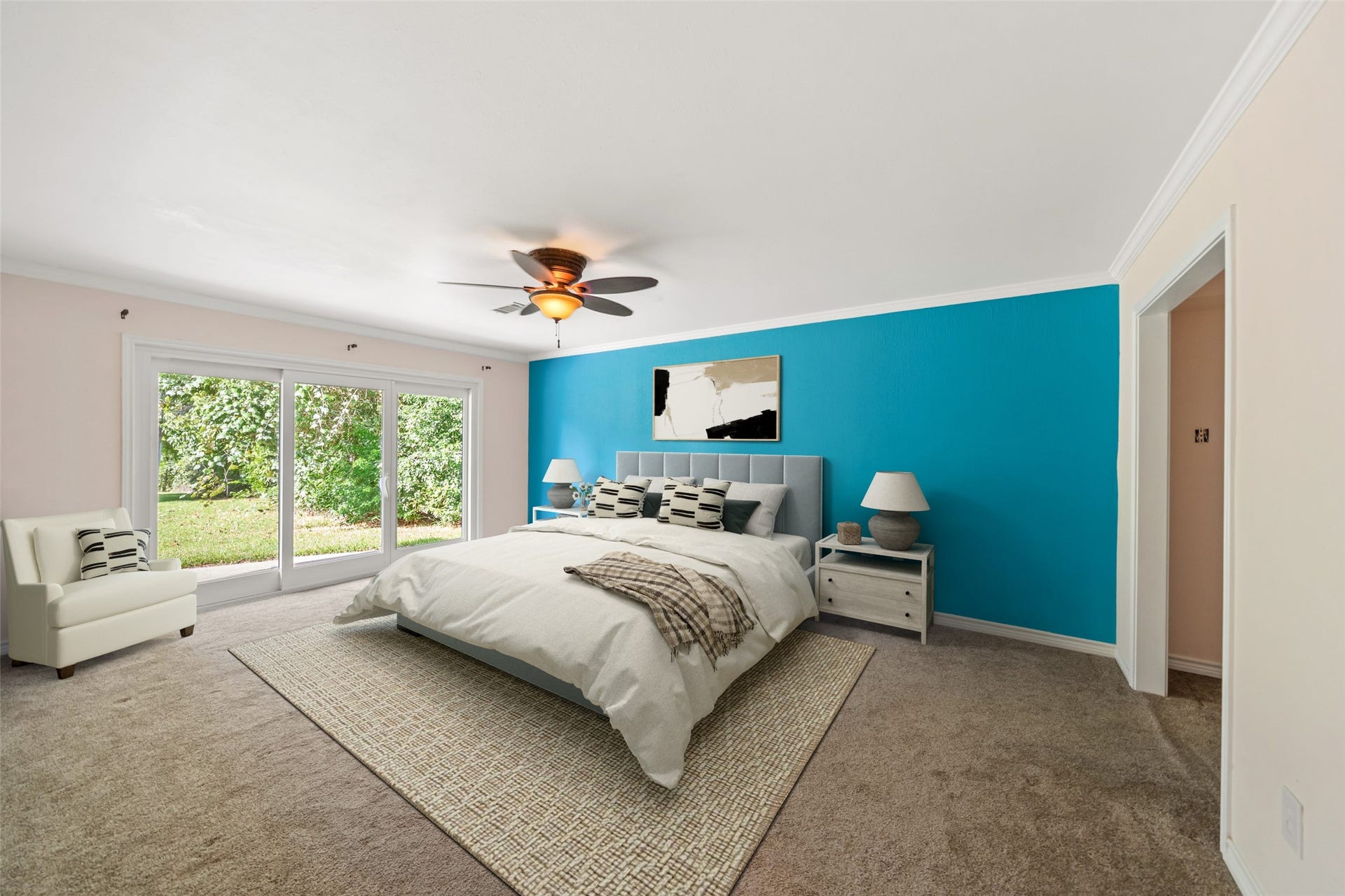 7714 Pecanwood Street, Hitchcock, TX 77563 One of the LARGE primary bedrooms in this beautiful property. Wake up to a gorgeous view of the water!! Doors lead out to the backyard patio. Perfect for a small seating area outside your back window.
