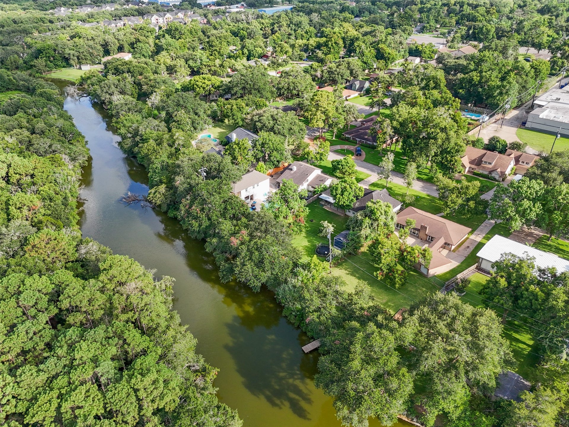 7714 Pecanwood Street, Hitchcock, TX 77563 The pier on the right seen below is for this home and leads directly to all of this beautiful water. Plenty of areas to explore in each direction!