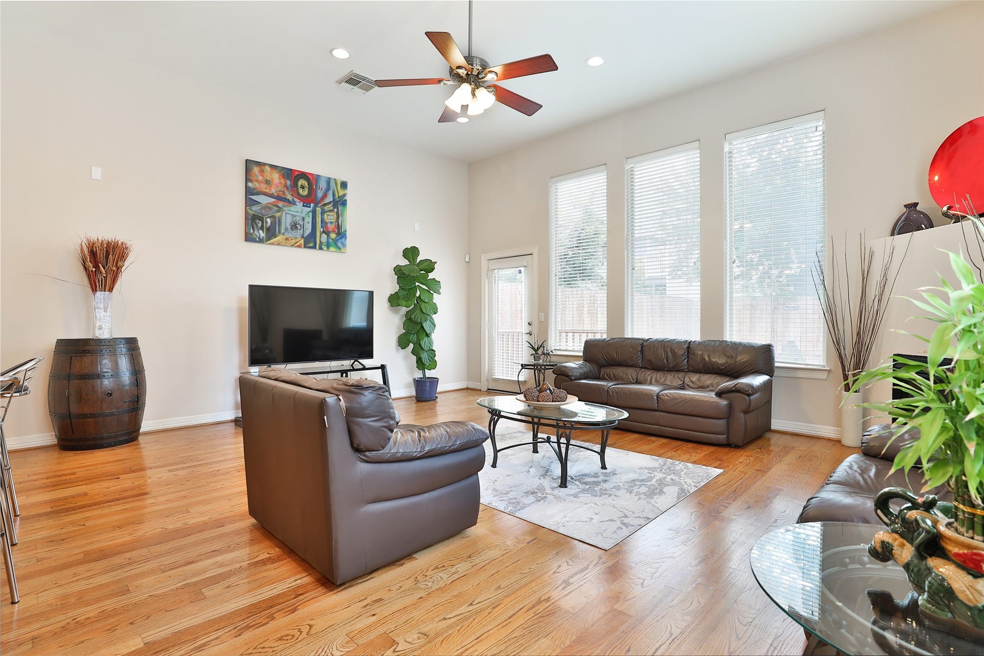 Spacious den with high ceilings, hardwood floors, and lots of natural light.