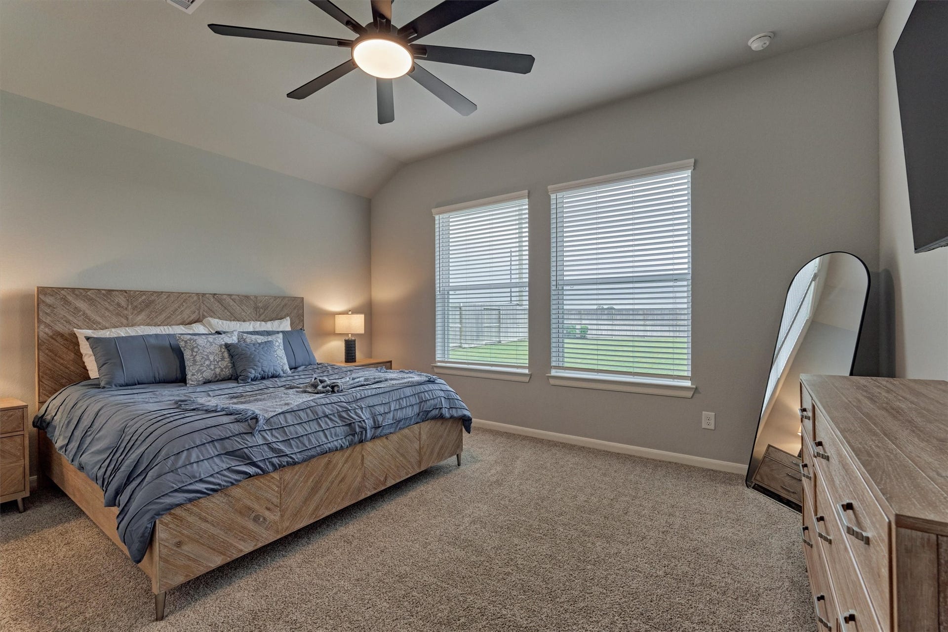 Secluded owner's suite is tucked off the main living area and features calming views of the private backyard.