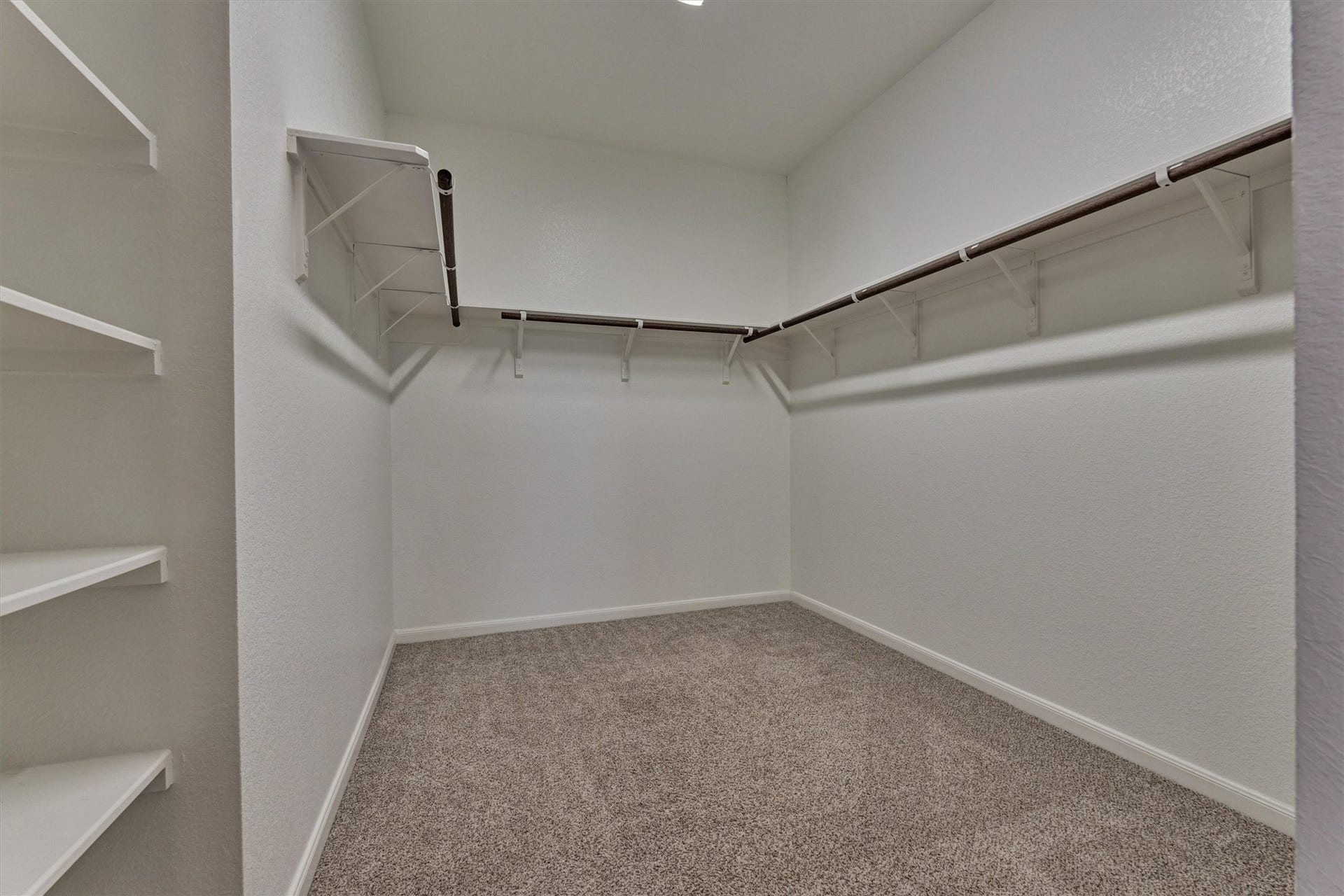 HUGE walk in closet features multiple storage options for the primary suite!