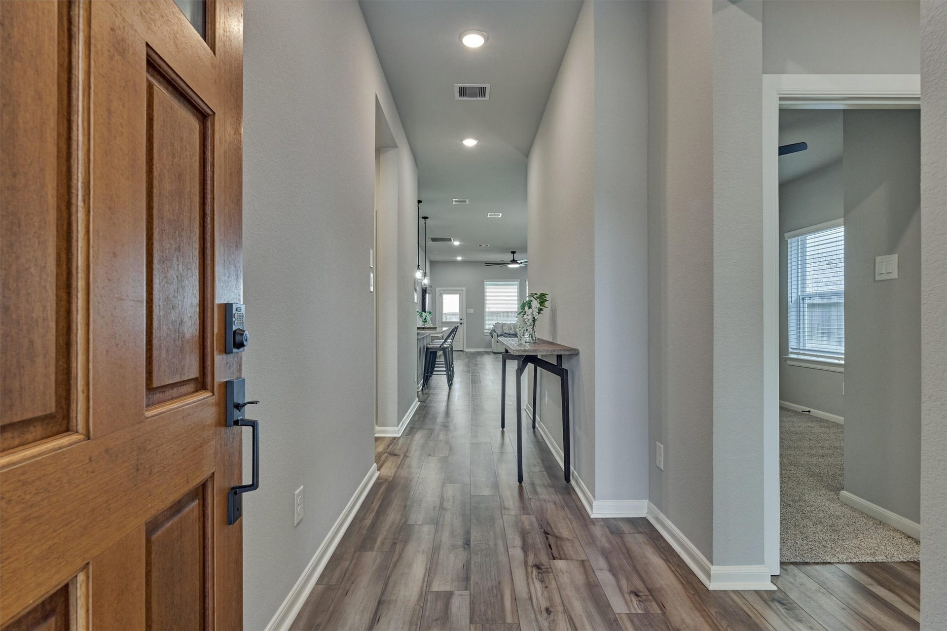 Spacious foyer showcases open sight lines to the rear of the home. Continuous LVP flooring throughout the main living areas for a seamless look!