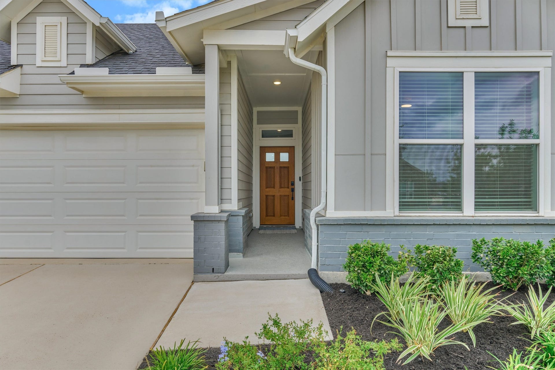 This home features improved landscaping and charming curb appeal!  Note the covered porch and attractive six panel front door!