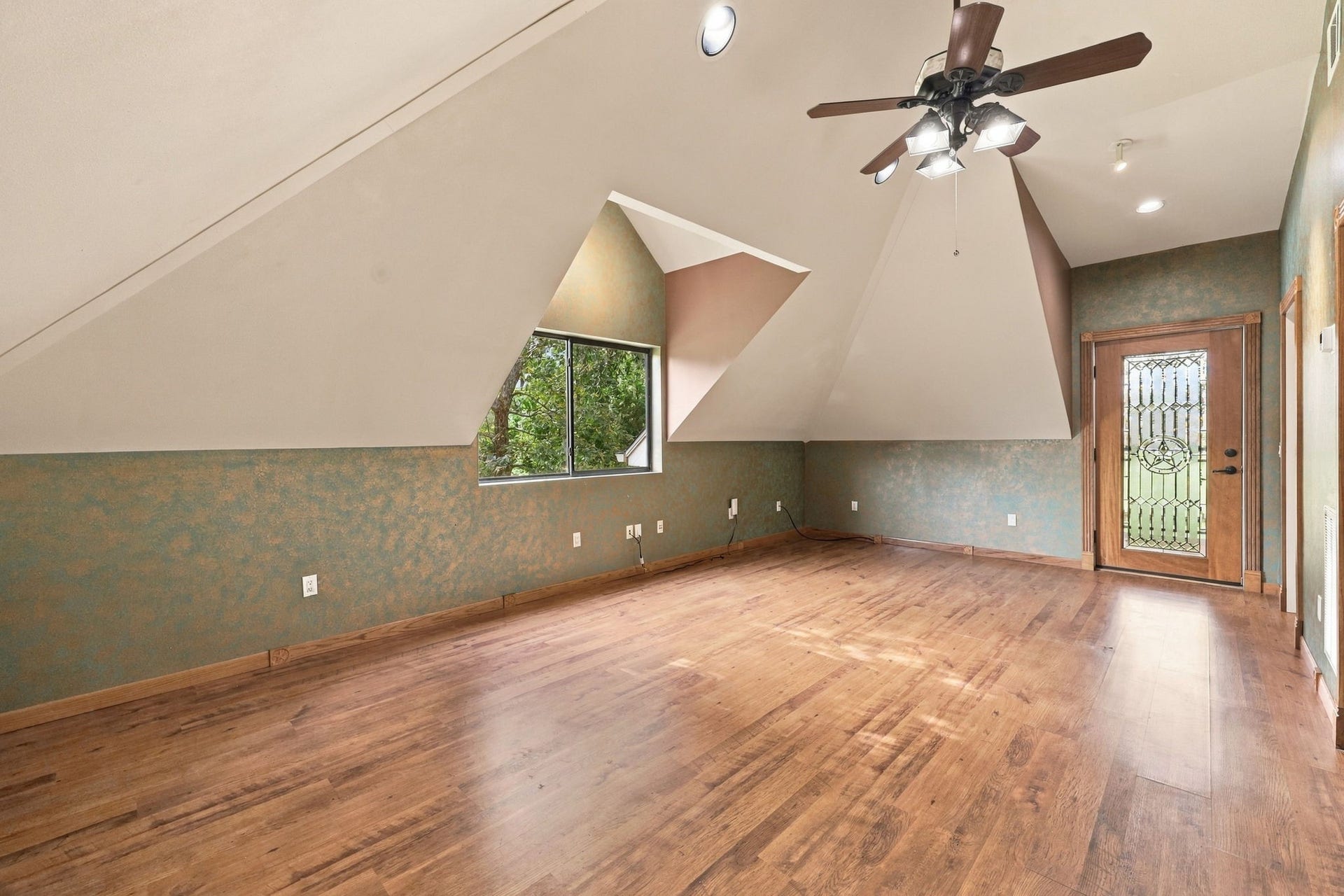 4711 Westerdale Drive, Fulshear, TX 77441 The Garage Apartment offers flexible living arrangements with the option of one or two Bedrooms, along with a Full Kitchen and Full Bath. This room can serve as a Bedroom and features wood-look luxury vinyl plank flooring, a walk-in closet, and a large window that brings in plenty of natural light.