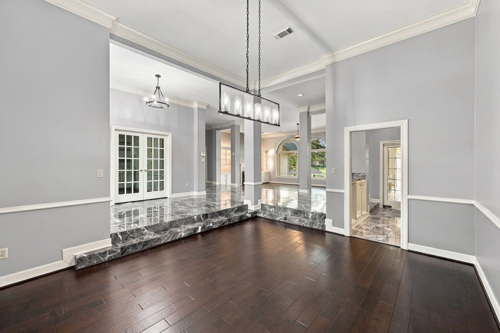4711 Westerdale Drive, Fulshear, TX 77441 From the opposite side of the Formal Dining Room, you'll notice the beautiful architectural columns and soothing neutral paint palette that carry throughout the home. The cohesive colors and thoughtful design create a seamless flow between the living spaces, enhancing the home's open and welcoming feel.
