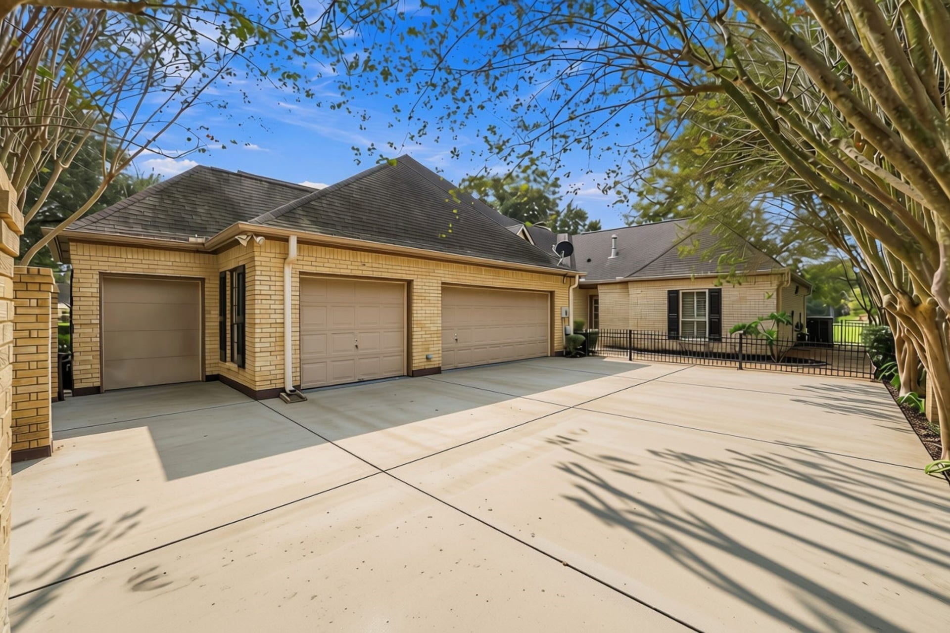 4711 Westerdale Drive, Fulshear, TX 77441 The main residence features a spacious courtyard entry, a 3-Car attached garage, and a separate golf cart garage, along with an abundance of driveway space for additional parking and guest accommodations.