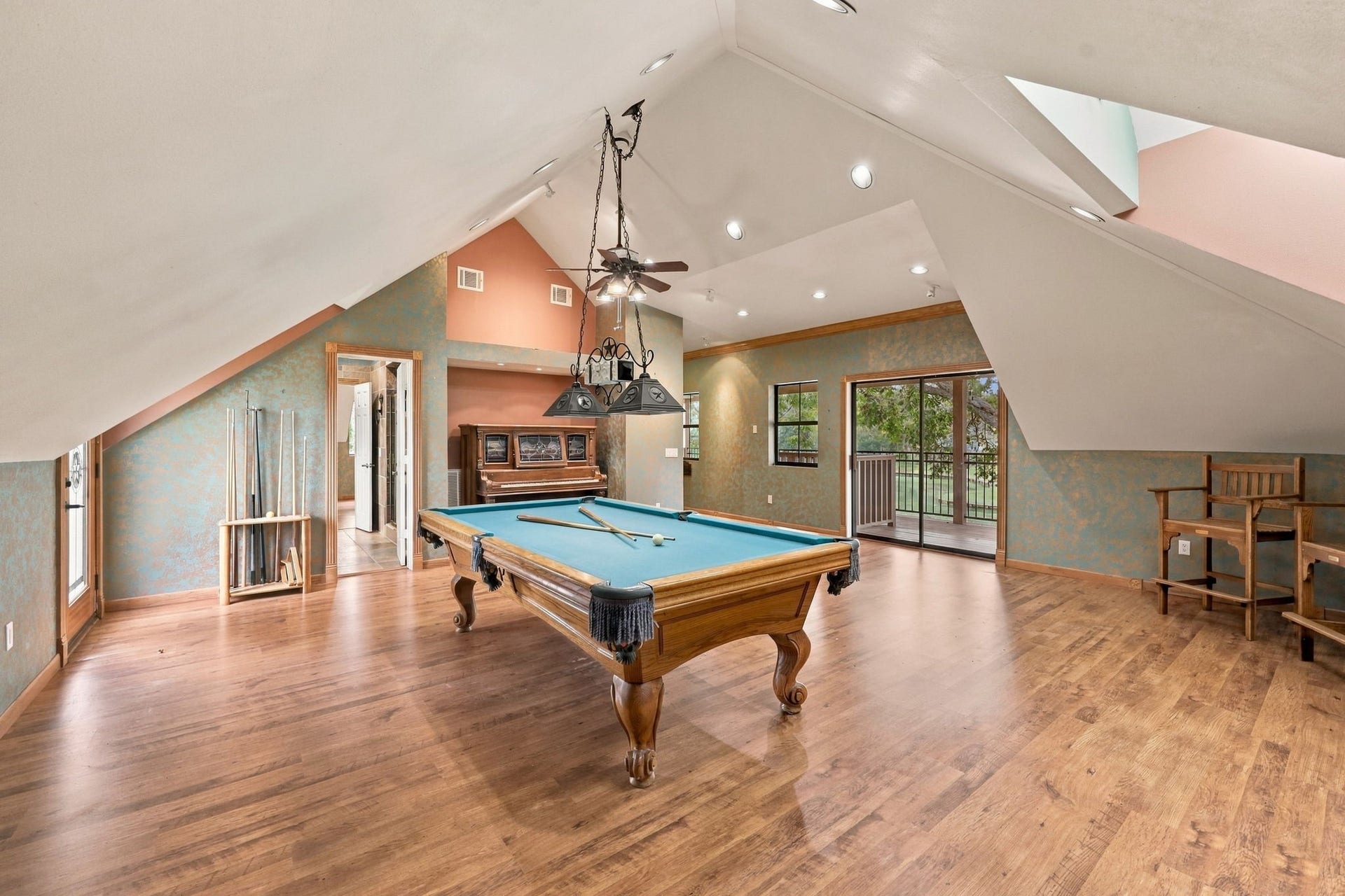 4711 Westerdale Drive, Fulshear, TX 77441 Take a look from the opposite side of the Game Room to appreciate the generous size of this versatile space, which offers convenient direct access to the full bath and two balconies overlooking the beautiful surroundings. The pool table will remain with the property; however, the piano is excluded from the sale.