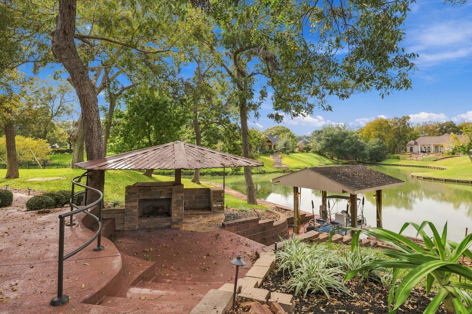 4711 Westerdale Drive, Fulshear, TX 77441 Additional features of this exceptional 1.06-acre estate include a charming outdoor fireplace with a metal roof, along with your very own pontoon boat and boat slip. Surrounded by lush landscaping and picturesque waterfront views, this outdoor setting is perfect for relaxing evenings, entertaining family and friends, and enjoying all the beauty this remarkable property has to offer.