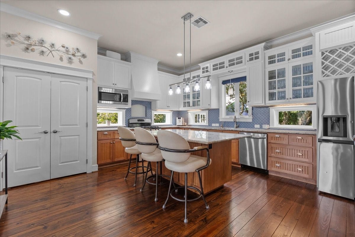 808 Elm Road, Clear Lake Shores, TX 77565 Spacious island kitchen with abundant cabinetry, counter seating and stainless appliances, boasting with natural light.