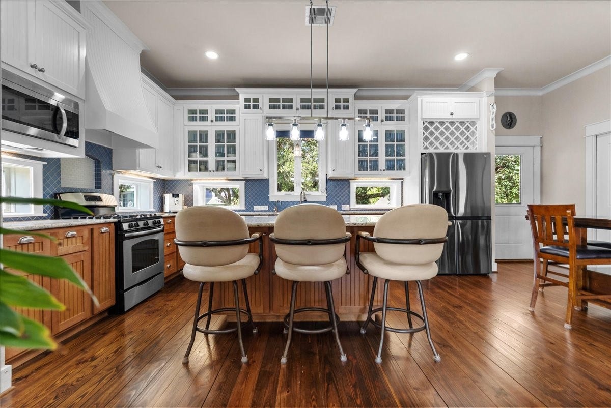 808 Elm Road, Clear Lake Shores, TX 77565 Bright, open kitchen featuring an oversized island and extensive custom cabinetry.