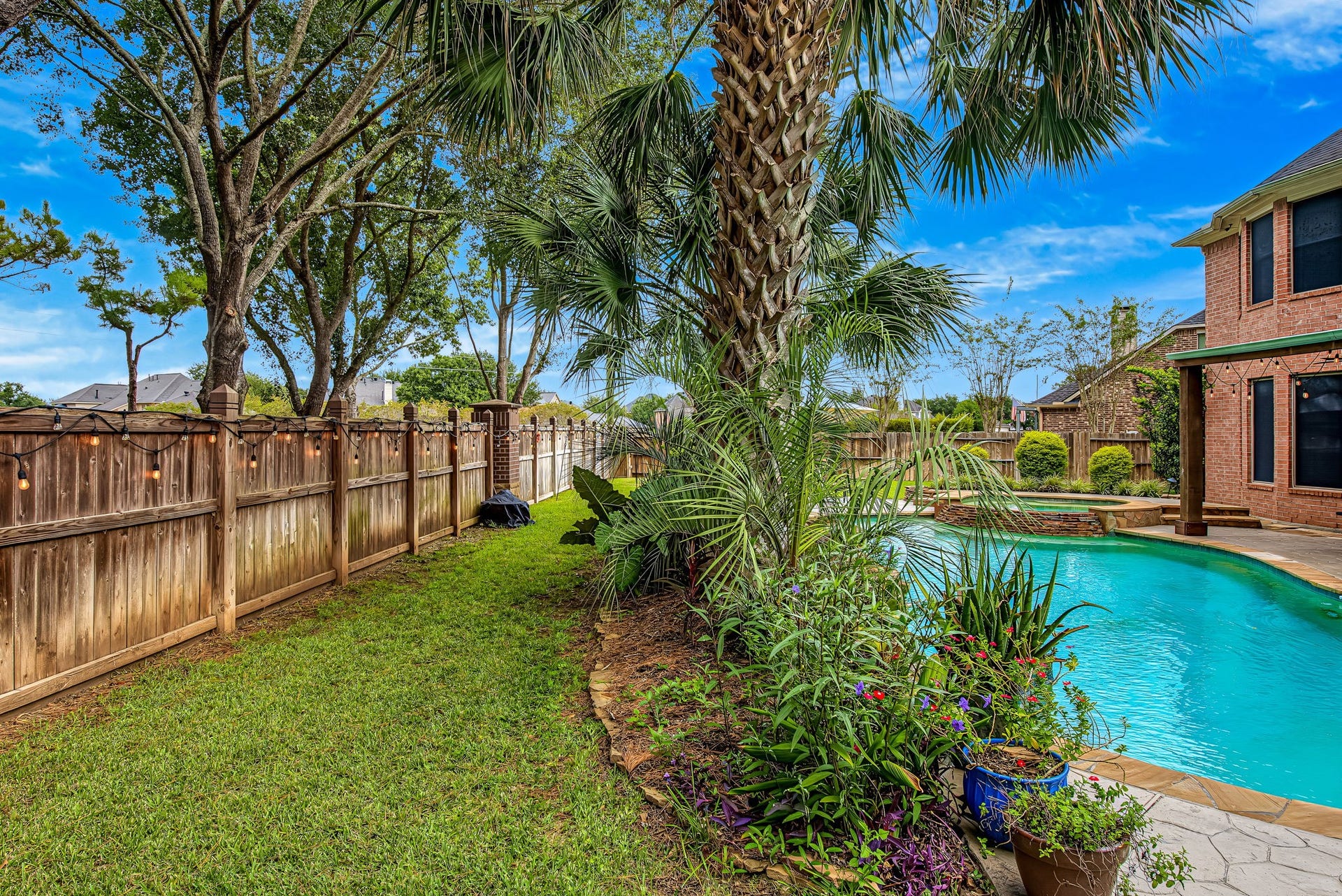 21223 Dover Park Lane, Katy, TX 77450 Lush greenery and a sparkling pool create a serene backyard oasis, perfect for relaxation and entertaining.