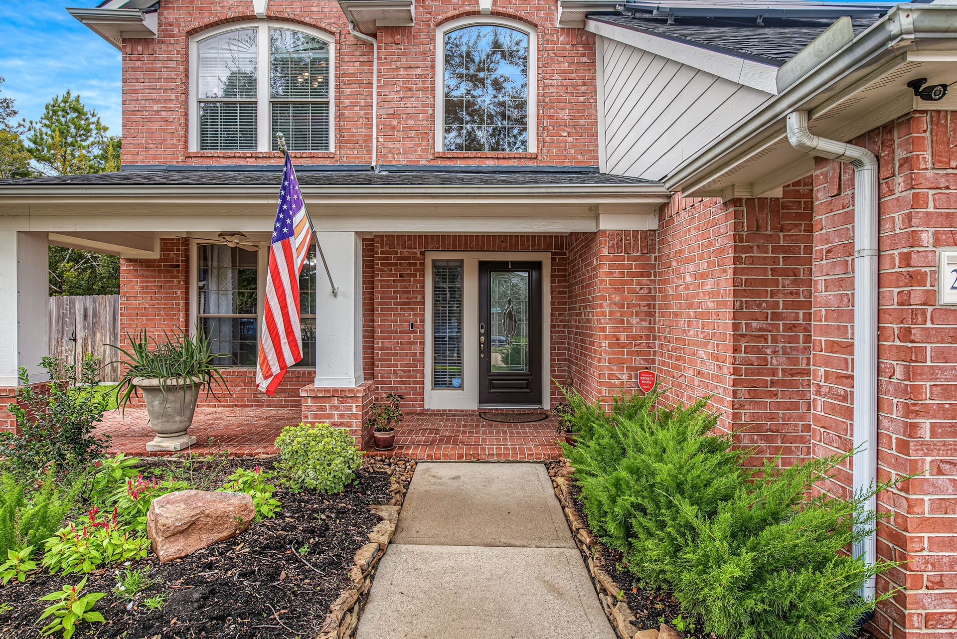 21223 Dover Park Lane, Katy, TX 77450 Charming brick faade with a welcoming covered front porch, complete with lush landscaping, perfect for sitting with your morning coffee.