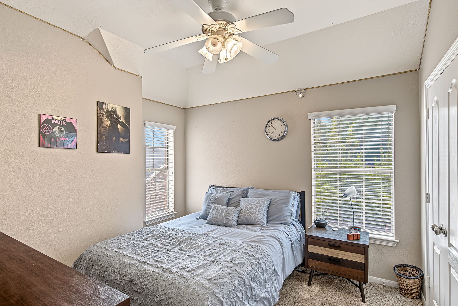 21223 Dover Park Lane, Katy, TX 77450 Cozy bedroom with a comfortable bed, soft carpeting, and natural light from two windows, complemented by a ceiling fan for added comfort.