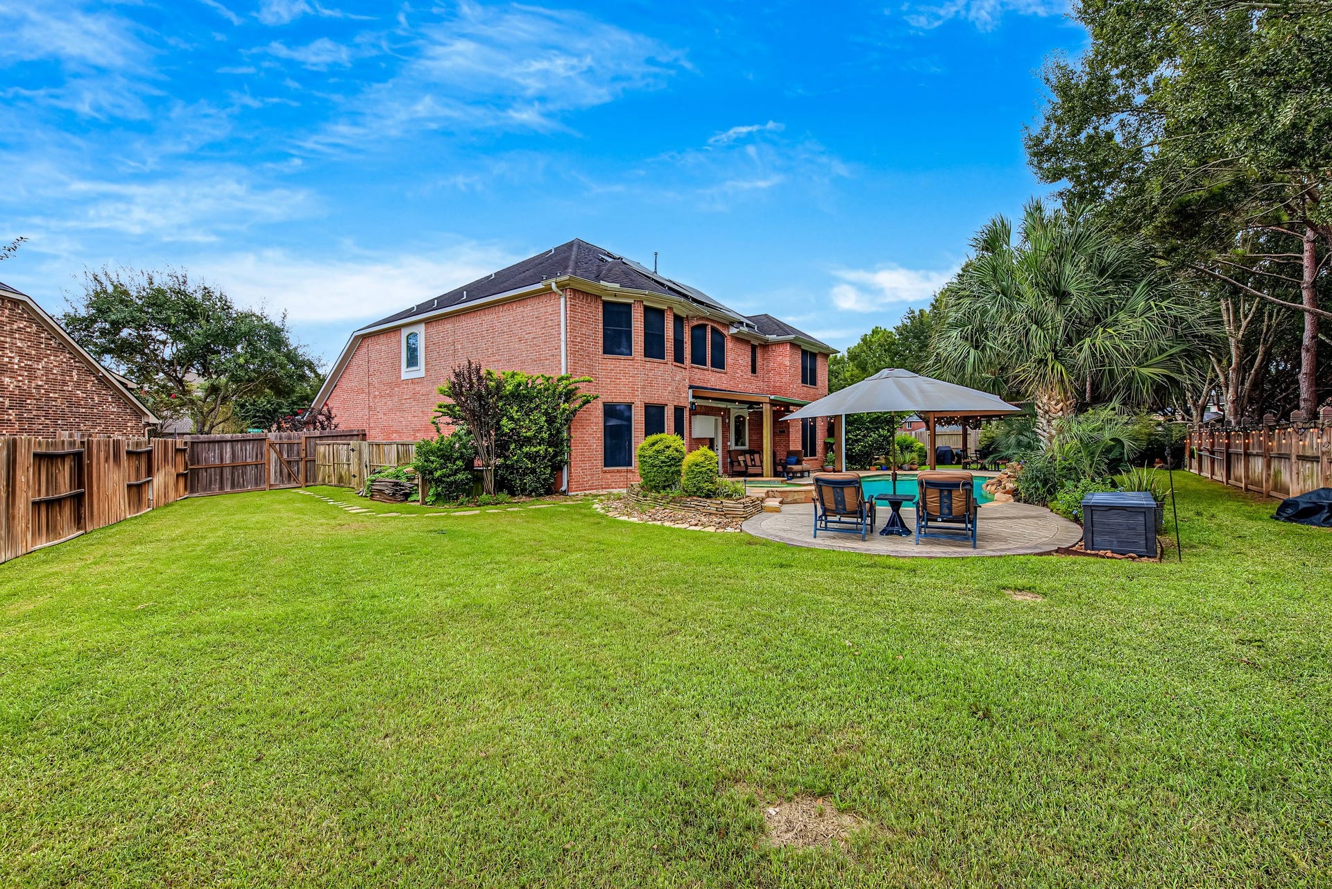 21223 Dover Park Lane, Katy, TX 77450 Expansive backyard with lush lawn, a charming gazebo, and a spacious patio perfect for outdoor entertaining, all surrounding a beautiful brick home.