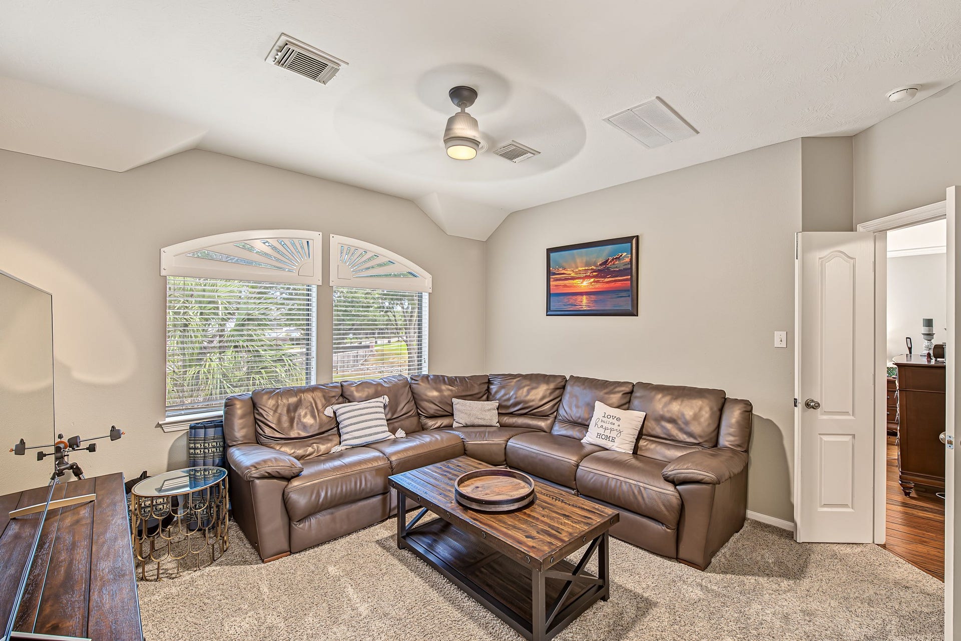 21223 Dover Park Lane, Katy, TX 77450 Cozy living area with plush leather sectional, soft carpet, and ample natural light from large windows.