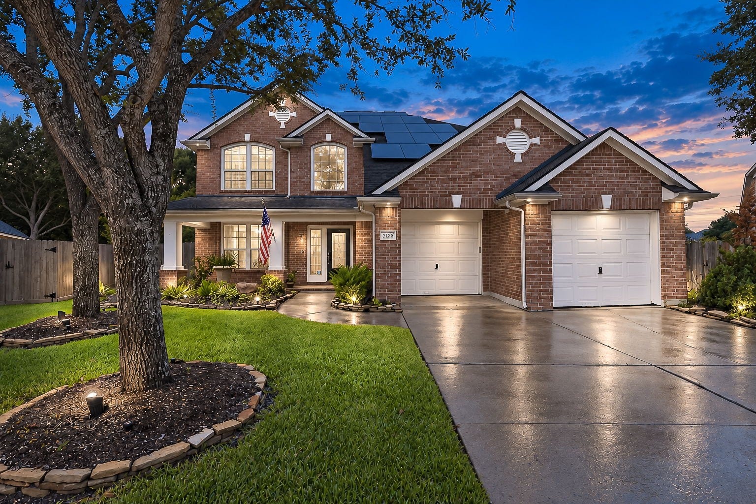 21223 Dover Park Lane, Katy, TX 77450 Charming two-story brick home with a double garage, beautifully landscaped front yard, set against a stunning sunset backdrop.