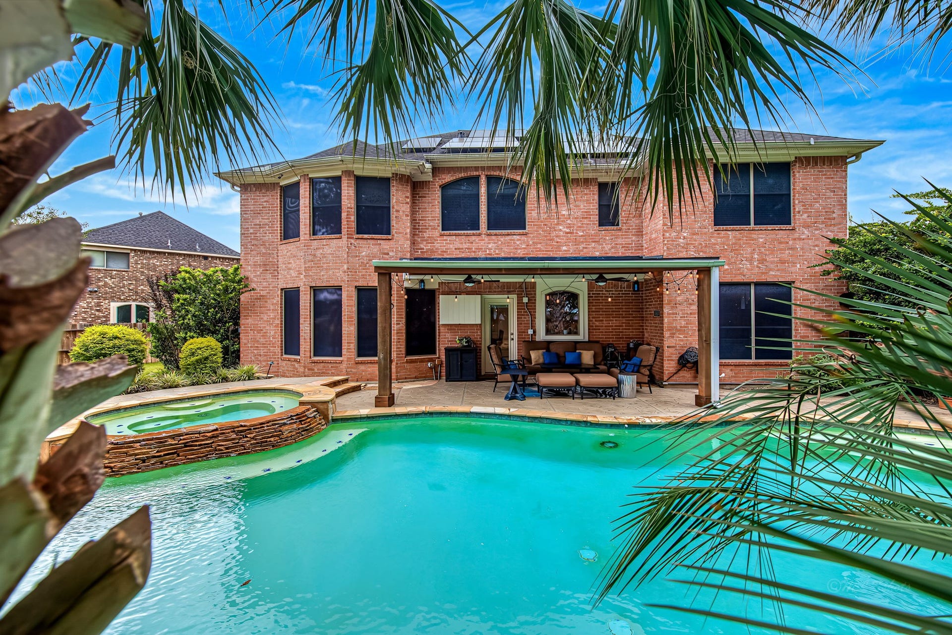 21223 Dover Park Lane, Katy, TX 77450 Stunning backyard oasis featuring a sparkling pool and spa, complemented by a spacious covered patio perfect for outdoor entertaining.